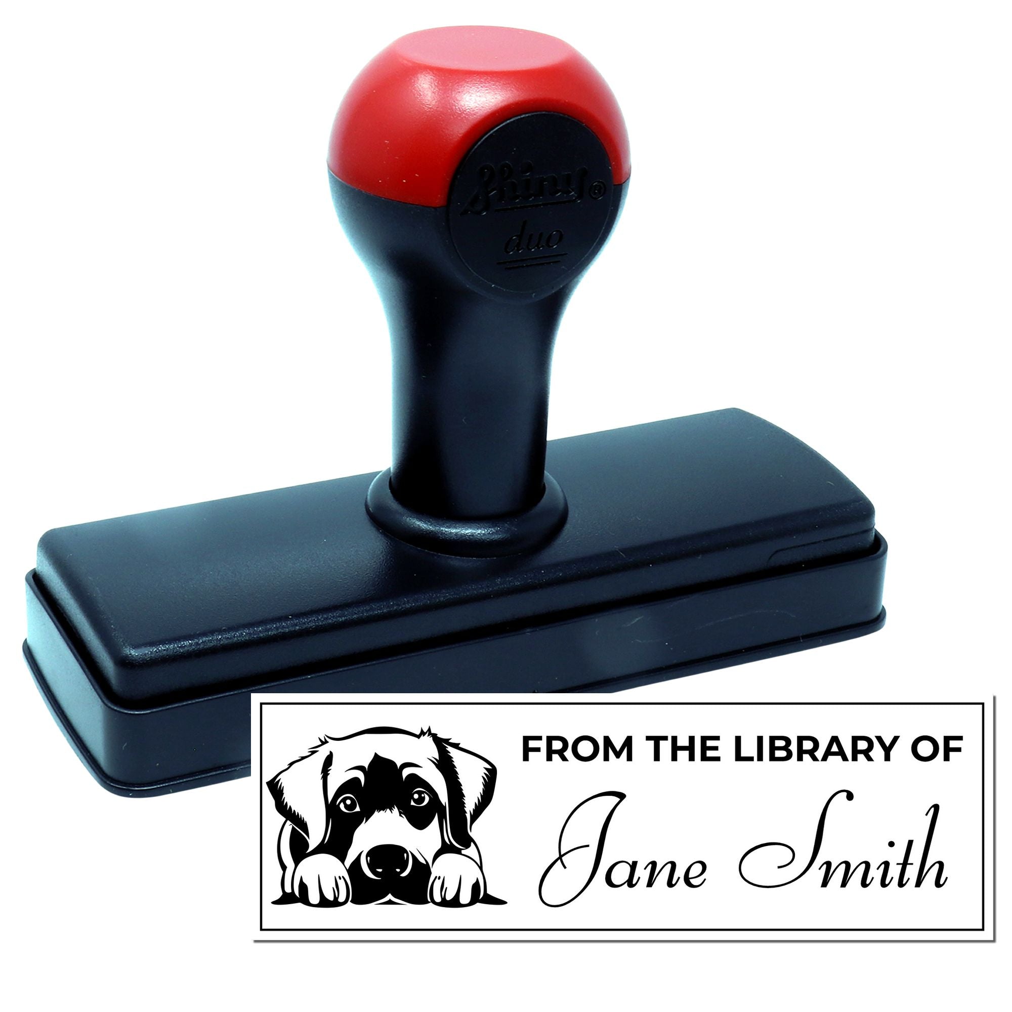 Custom self-inking rubber stamp with personalized From the Library of dog design for book labeling and library branding.
