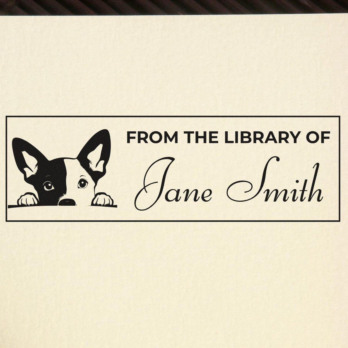 Personalized rubber stamp for library books featuring a dog and From the Library of Jane Smith name imprint.
