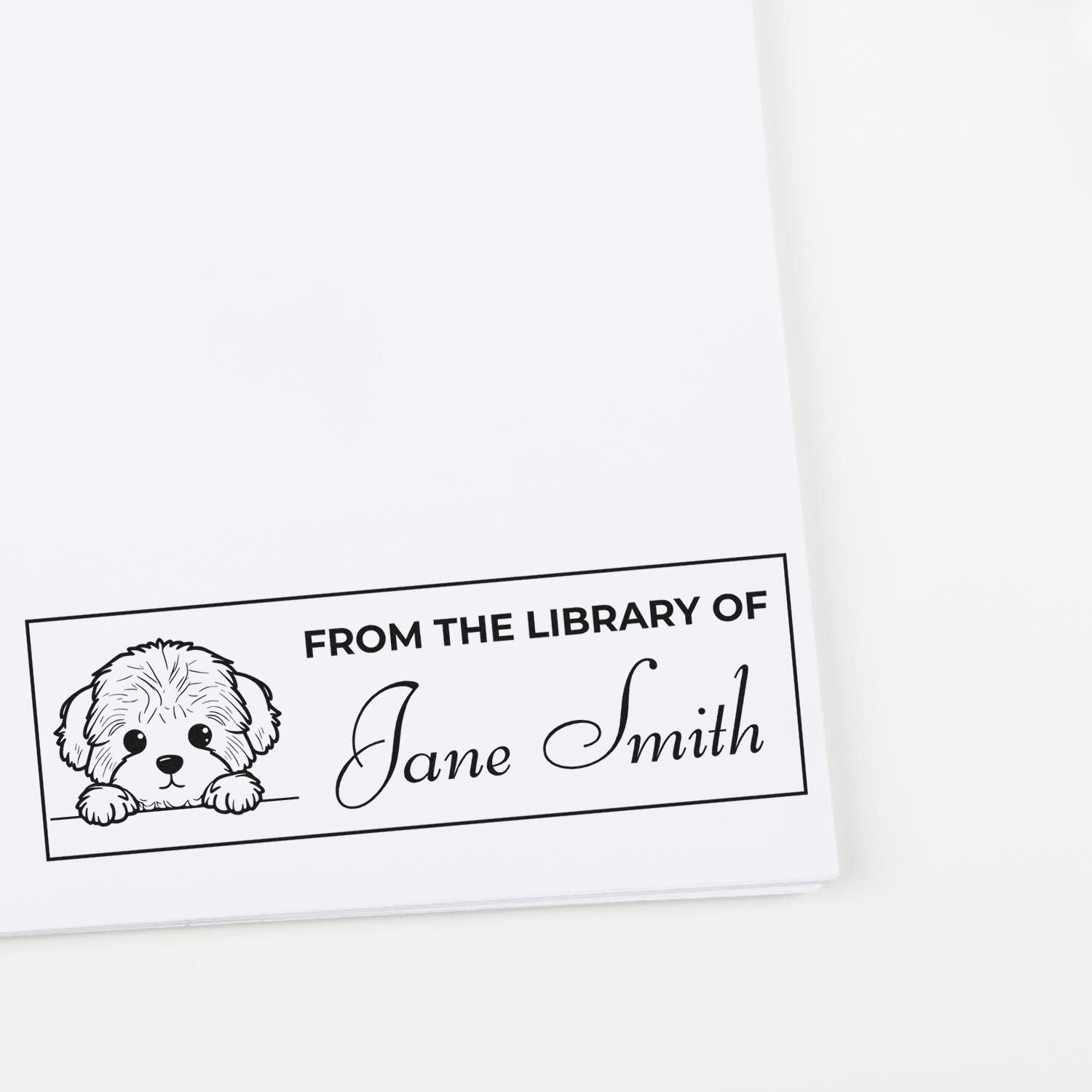 Personalized library book rubber stamp with dog illustration, reading From the Library of Jane Smith.