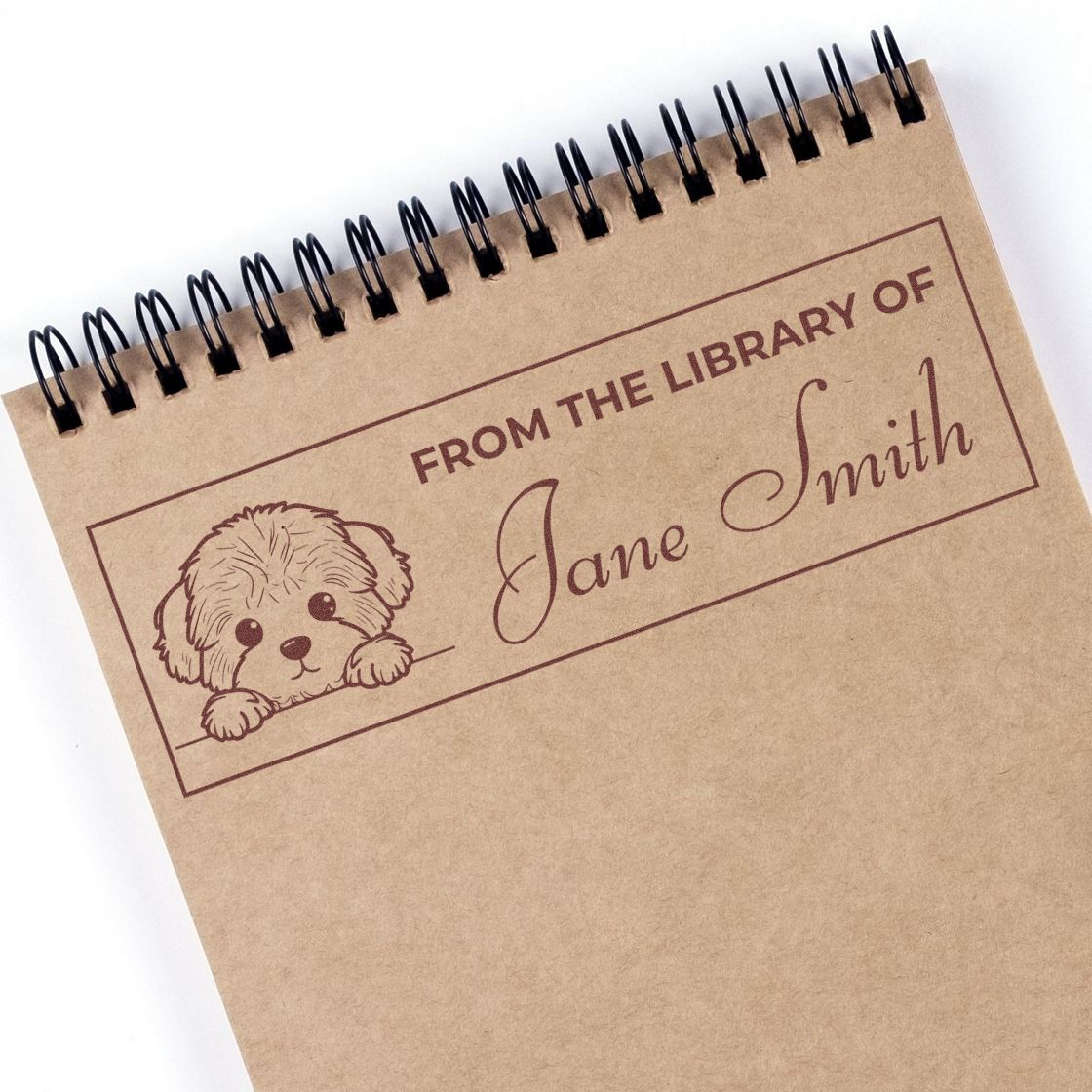 Custom pet-themed library rubber stamp on a spiral notebook, featuring From the Library of Jane Smith personalized bookplate design.