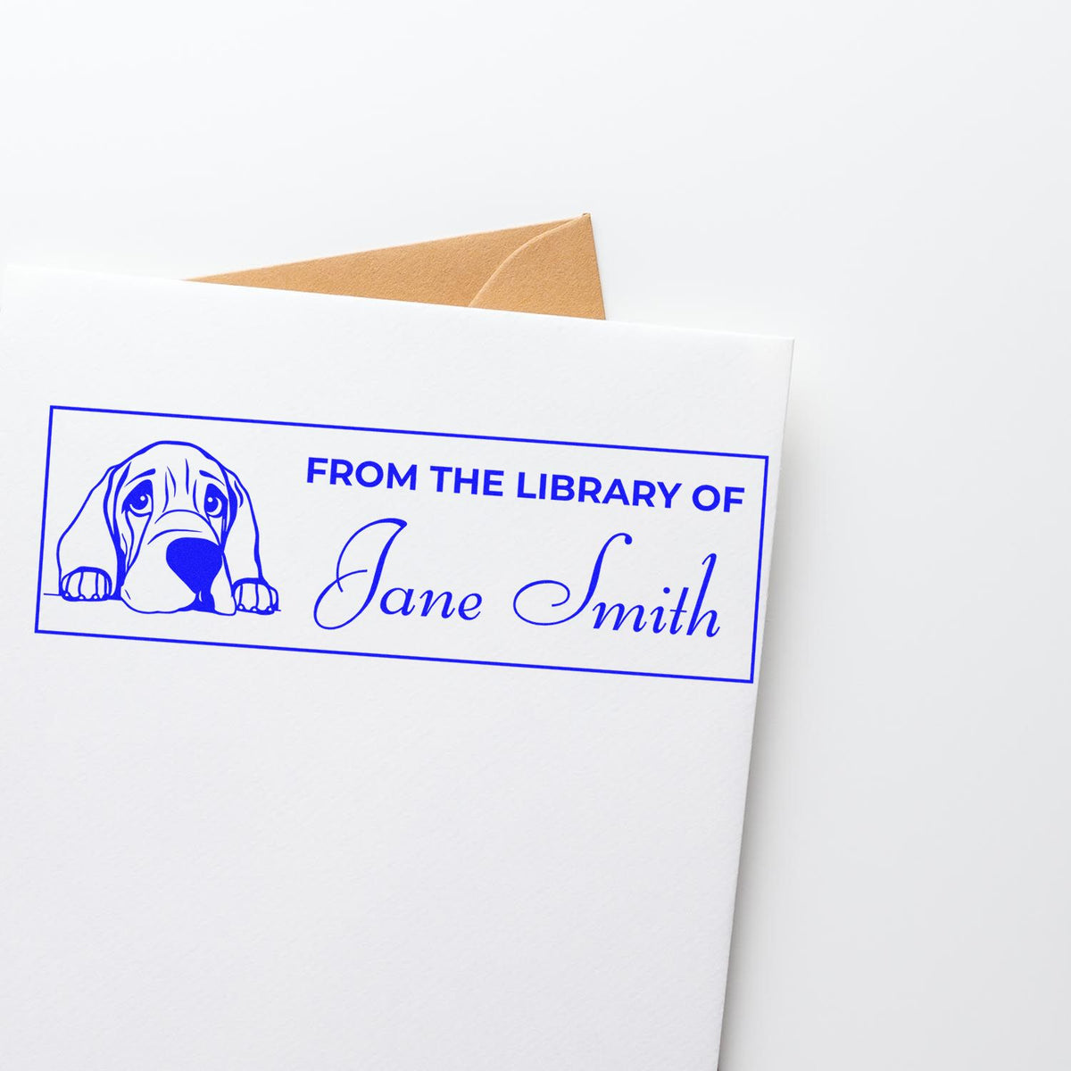 Custom rubber stamp with dog design reading From the Library of Jane Smith for personalized book ownership.