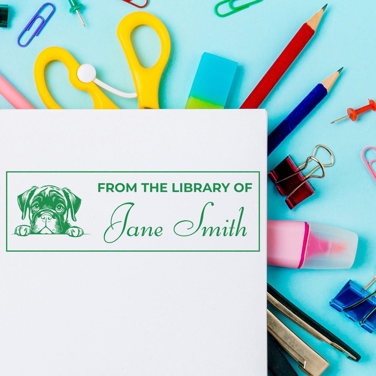 Personalized library rubber stamp with puppy design and From the Library of Jane Smith imprint on paper.