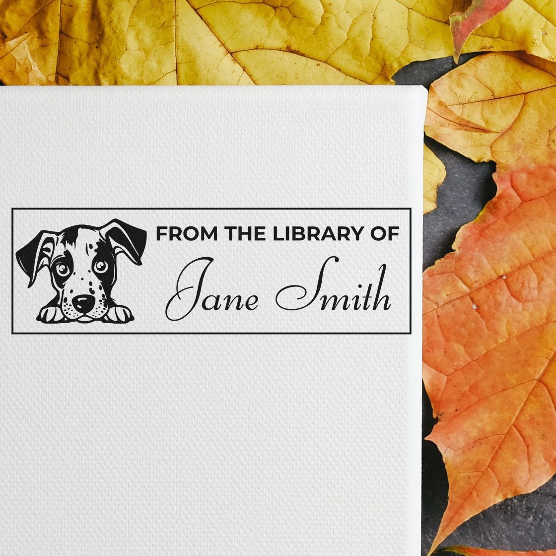 Custom rubber library stamp reading "From the Library of Jane Smith" with dog illustration for personalized books.
