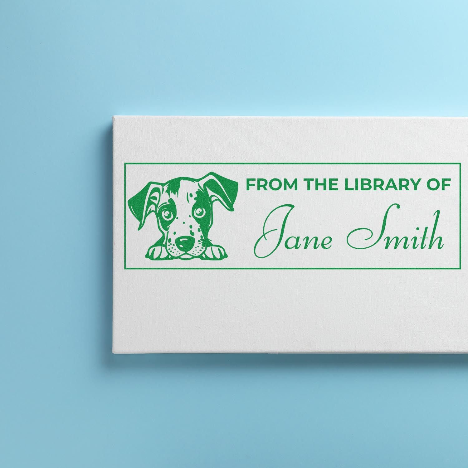 Personalized library rubber stamp with dog illustration and From the Library of Jane Smith text for book labeling.