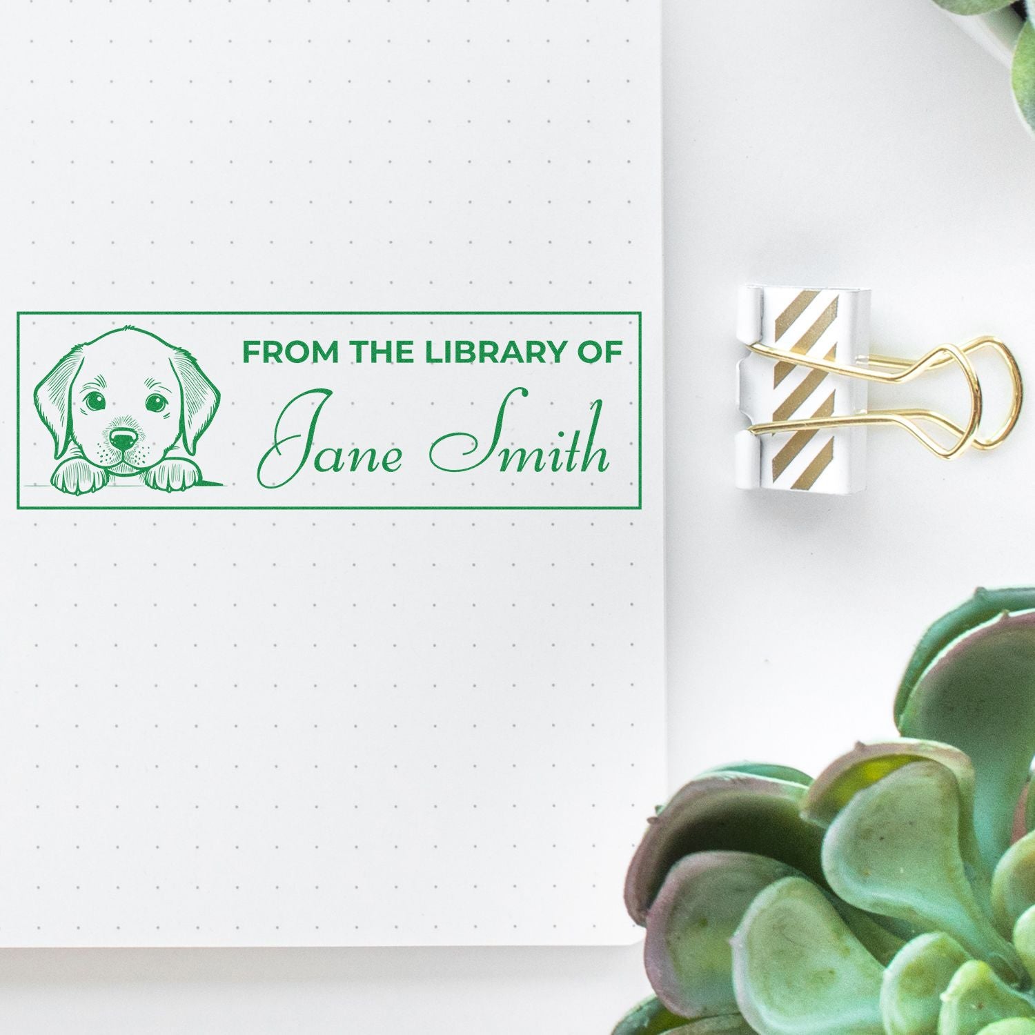 Custom rubber stamp with puppy illustration and From the Library of Jane Smith text for personalized bookplate labeling.