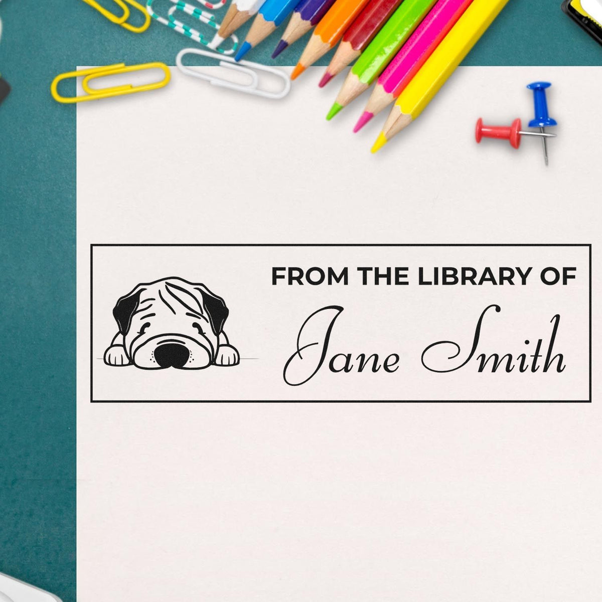 Custom From the Library Of rubber stamp with dog design and personalized name, perfect for book lovers and library organization.