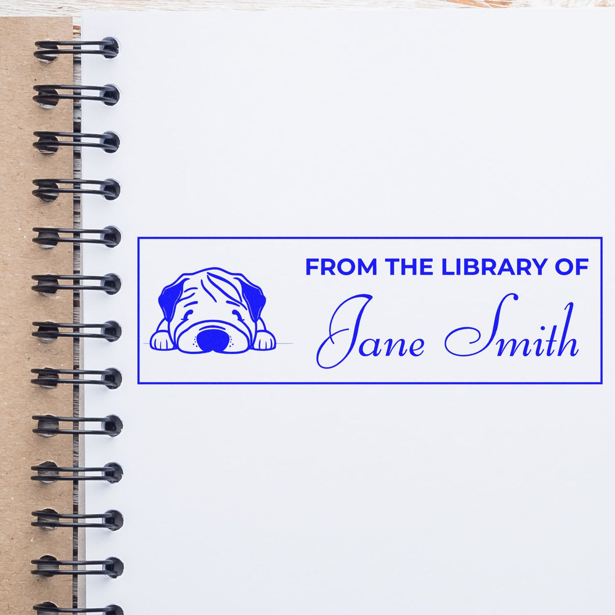 Personalized rubber book stamp with dog icon and From the Library of Jane Smith text for custom ex libris labeling.