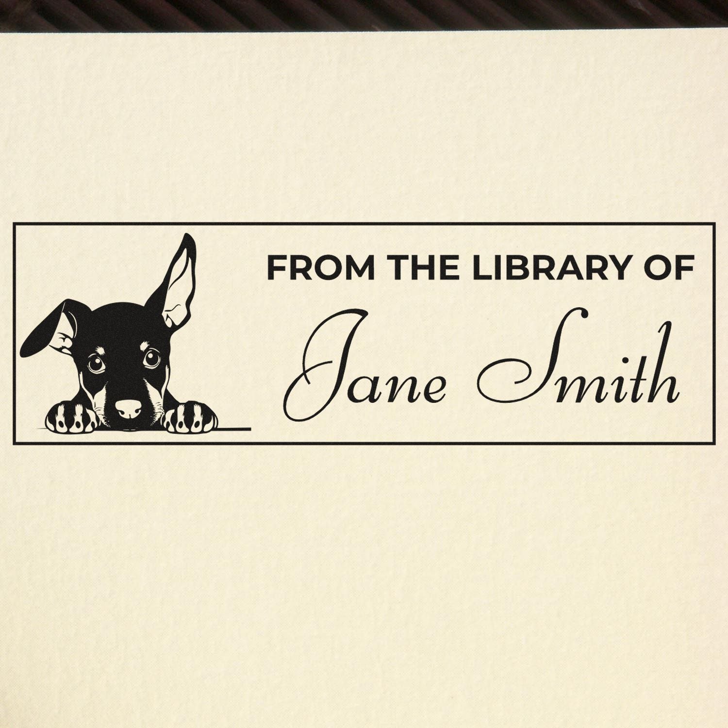 Custom library rubber stamp with puppy, reading From the Library of Jane Smith for personalized bookplate marking.