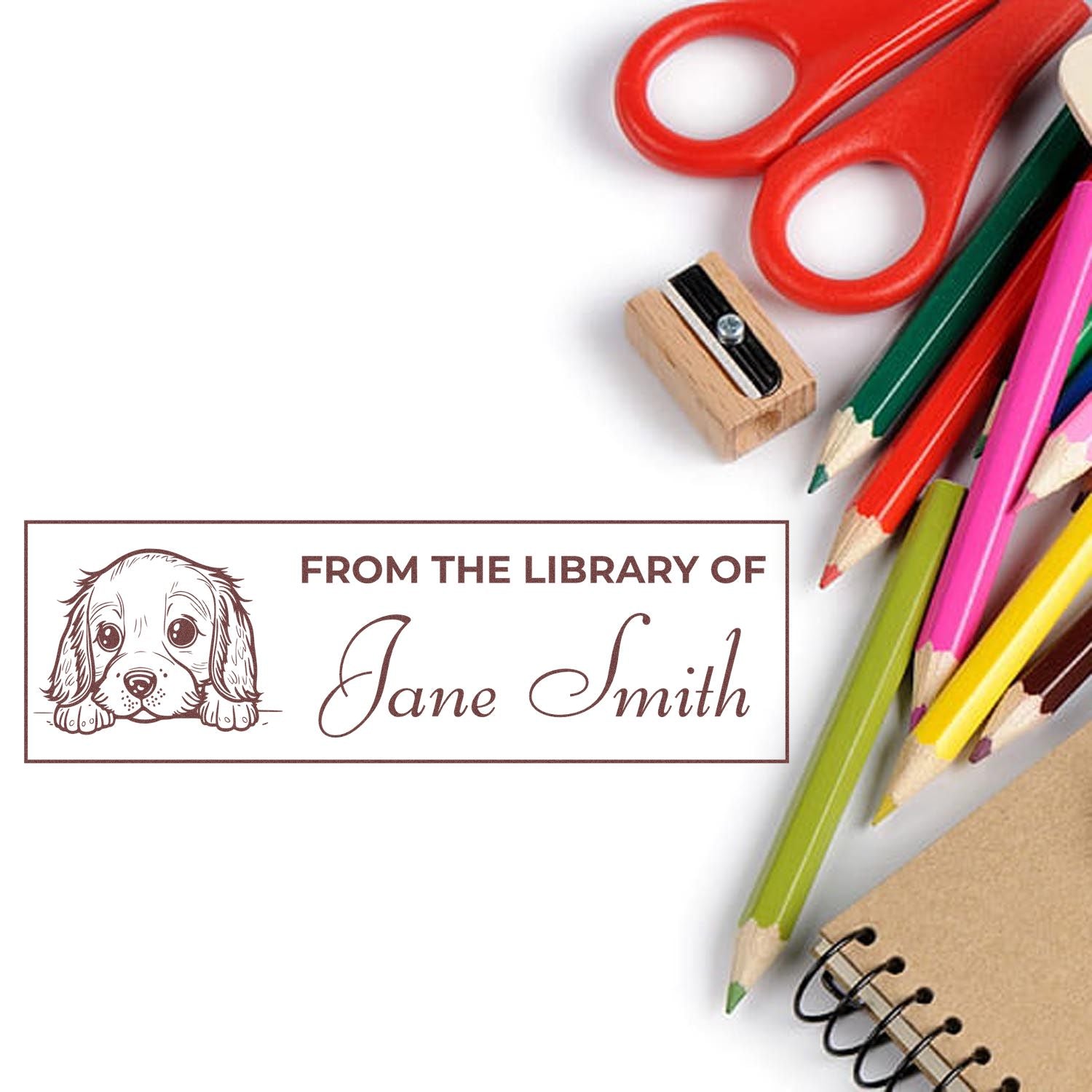 Personalized library rubber stamp with dog design reading From the Library of Jane Smith for book labeling.