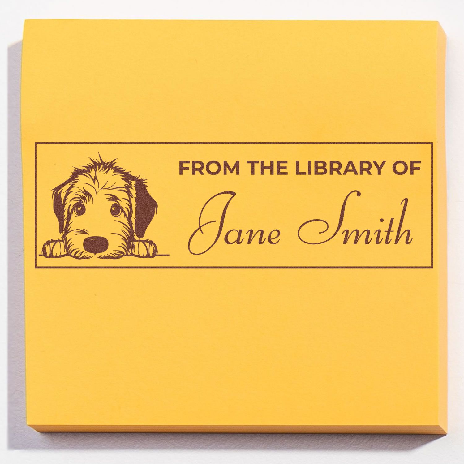 Custom rubber stamp with dog illustration and From the Library of Jane Smith personalized library bookplate on yellow paper