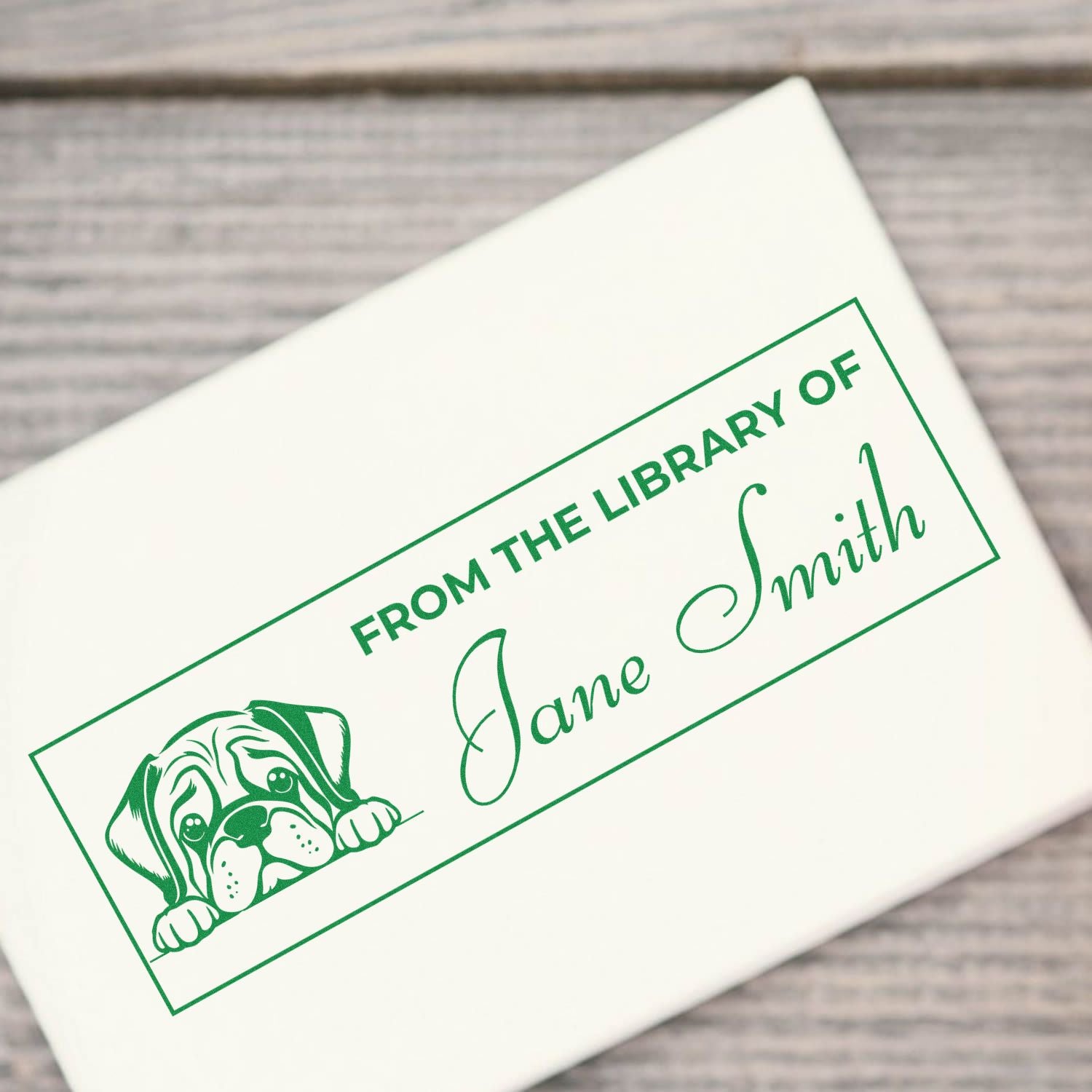 Custom rubber bookplate stamp with dog illustration and From the Library of Jane Smith on a white envelope.