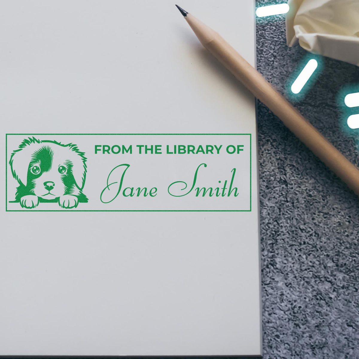 Personalized rubber book stamp with puppy design and From the Library of Jane Smith text.