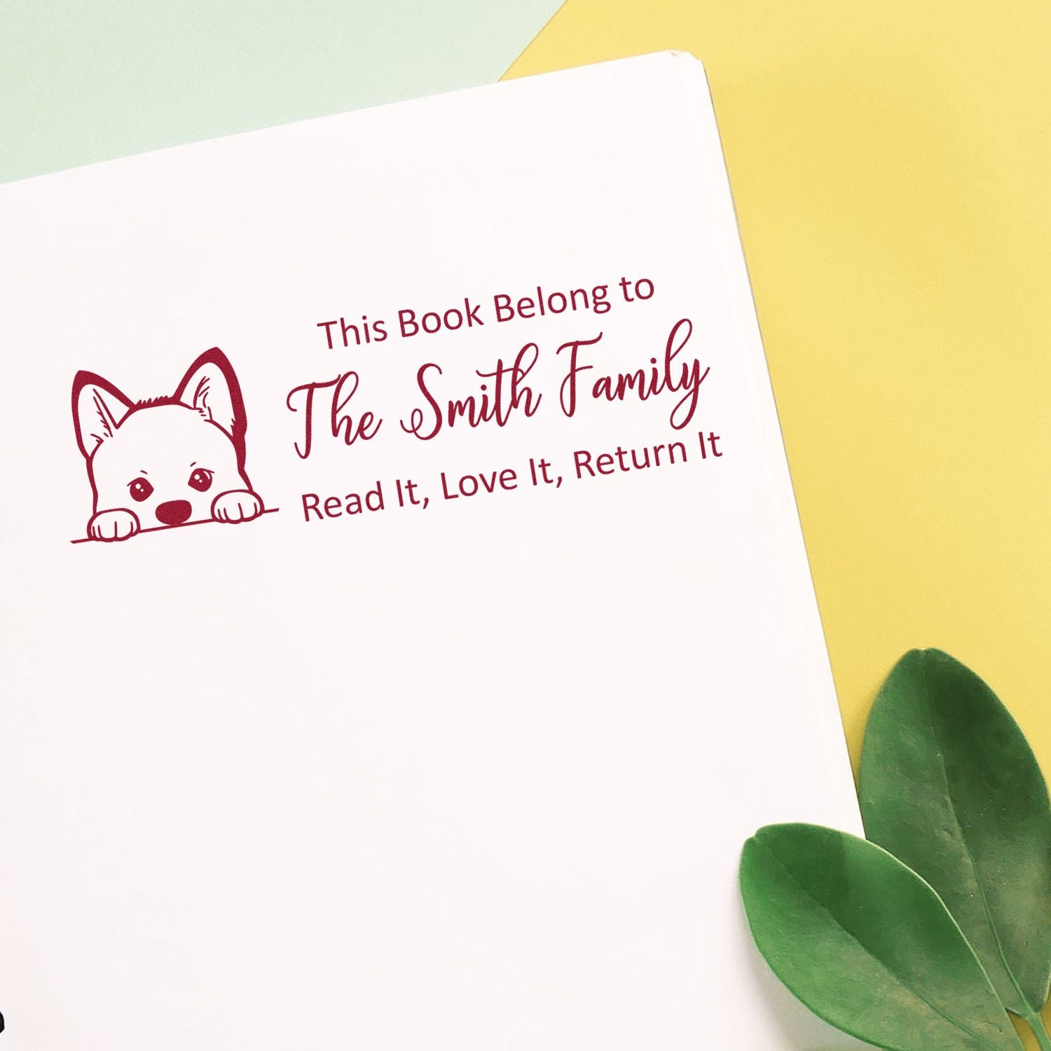 Custom book stamp with dog design reading This Book Belong to The Smith Family and return-it message.