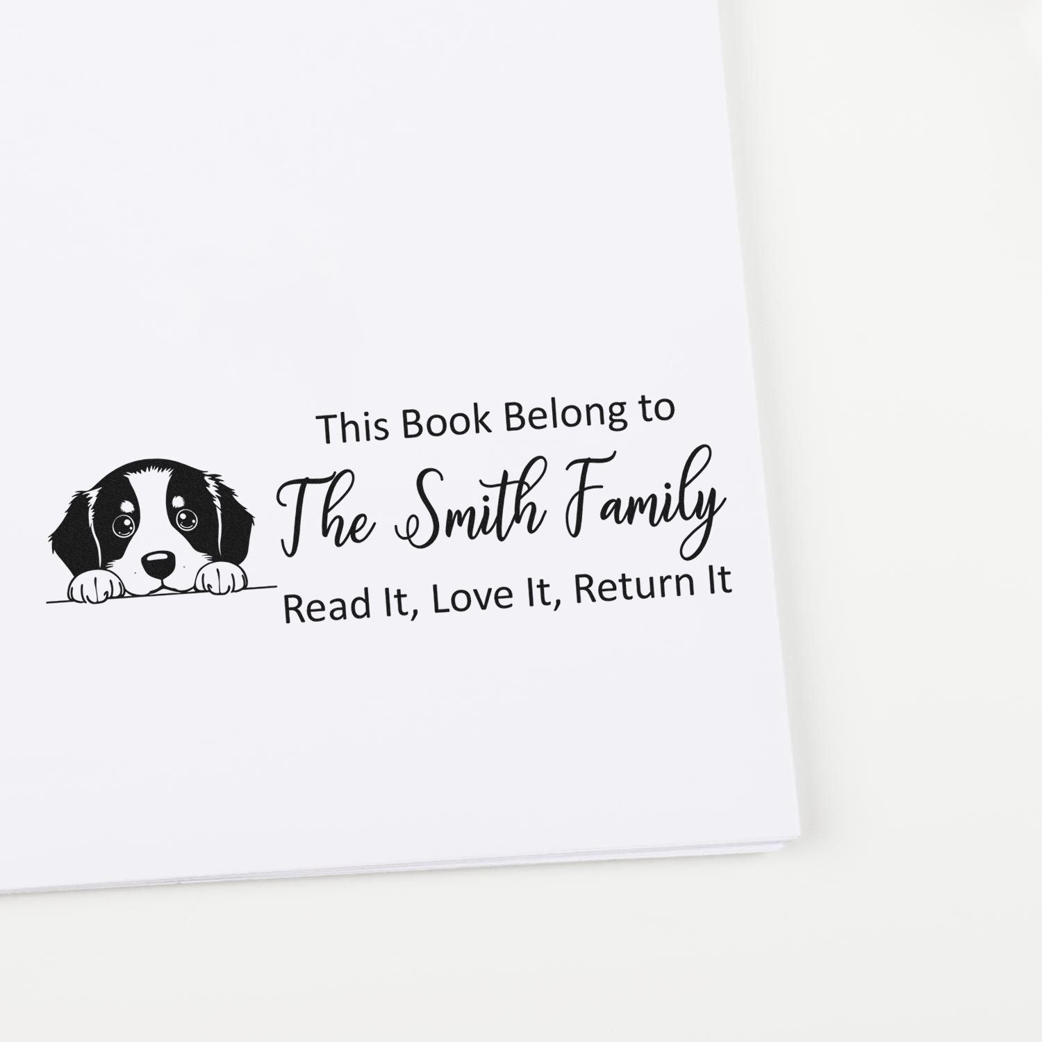 Custom rubber book stamp with dog illustration for The Smith Family, reading This Book Belongs to... Read It, Love It, Return It.