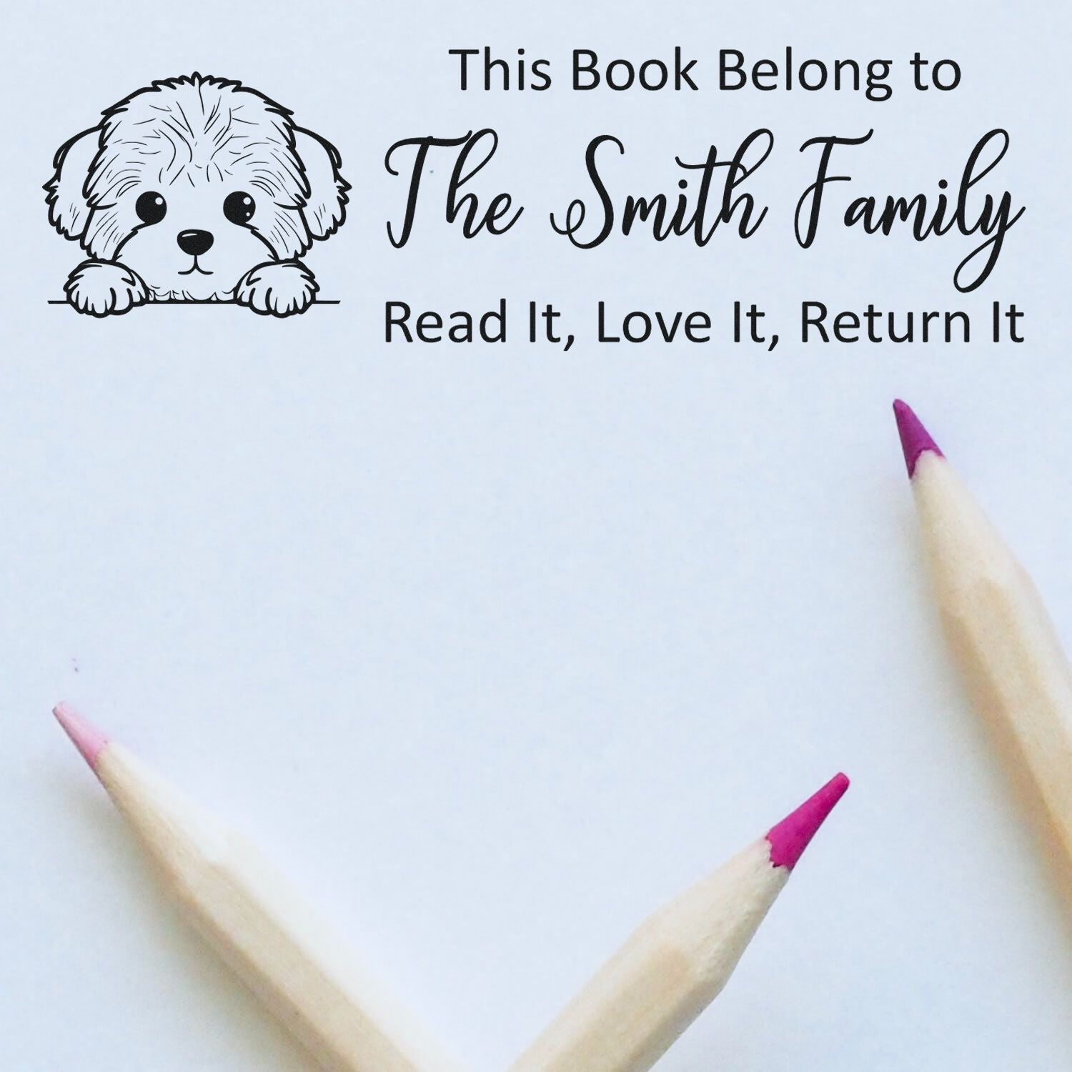 Custom rubber stamp for personalized book labels, featuring puppy design and This Book Belongs to The Smith Family message.