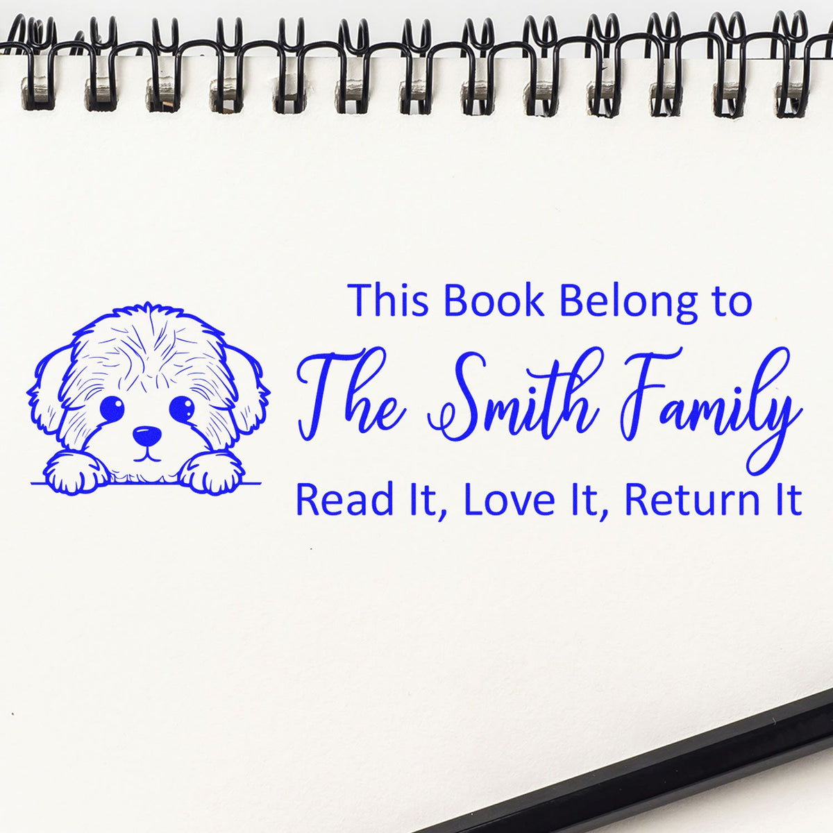 Personalized rubber book stamp with dog illustration and This Book Belong to The Smith Family, Read It, Love It, Return It.