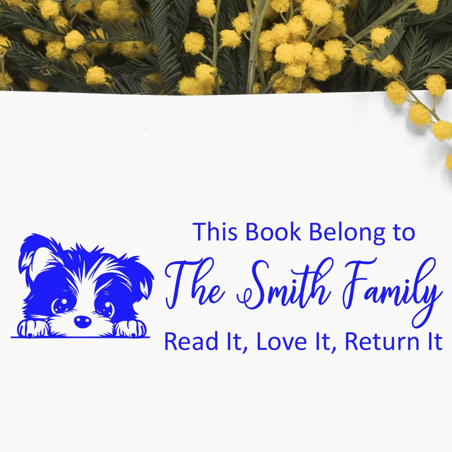 Personalized rubber book stamp with dog art and This Book Belongs to The Smith Family return-it message.