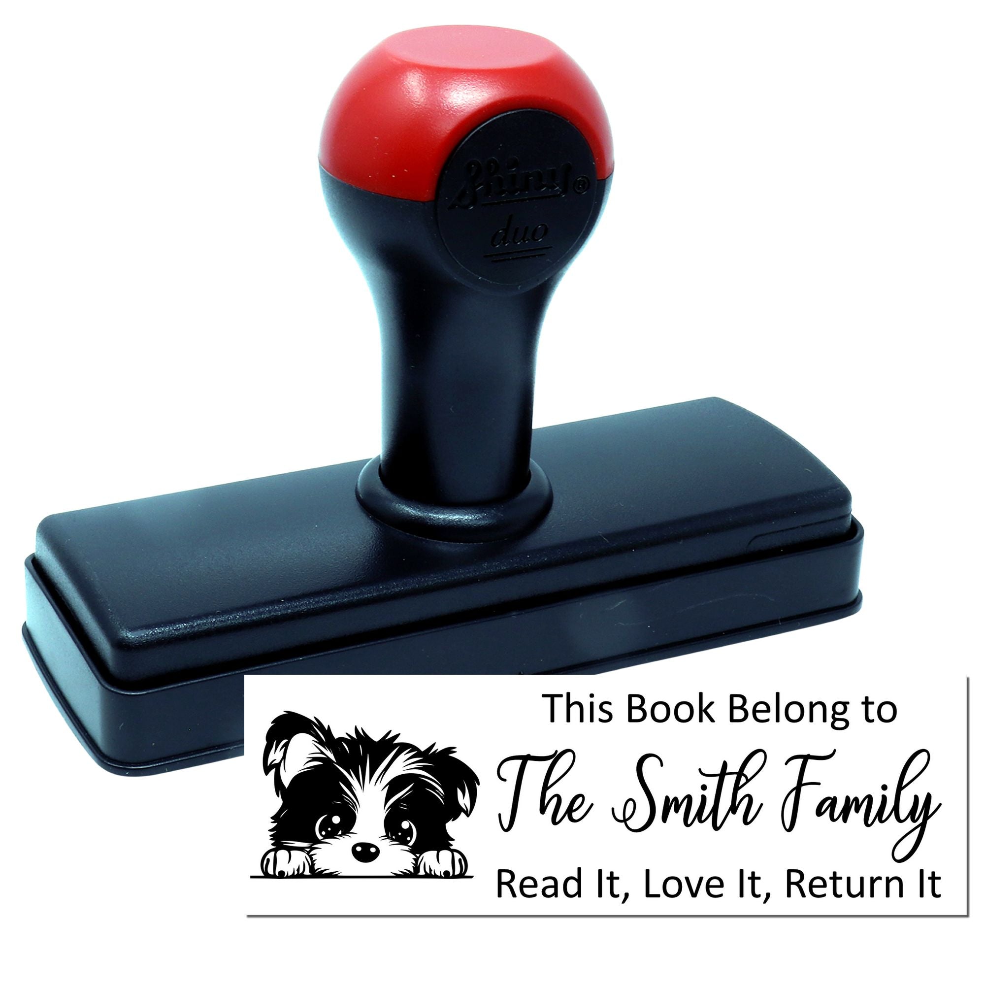 Self-inking custom book rubber stamp with puppy design and family name imprint, saying Read it, Love it, Return it.