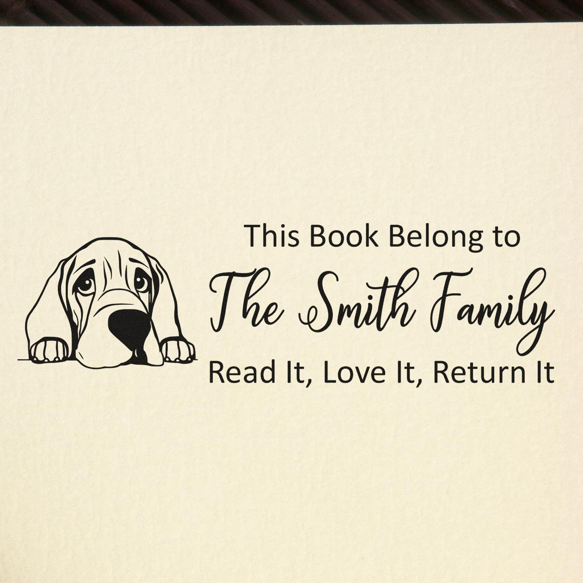 Personalized rubber stamp bookplate with dog illustration and This Book Belongs to The Smith Family, Read It, Love It, Return It text.