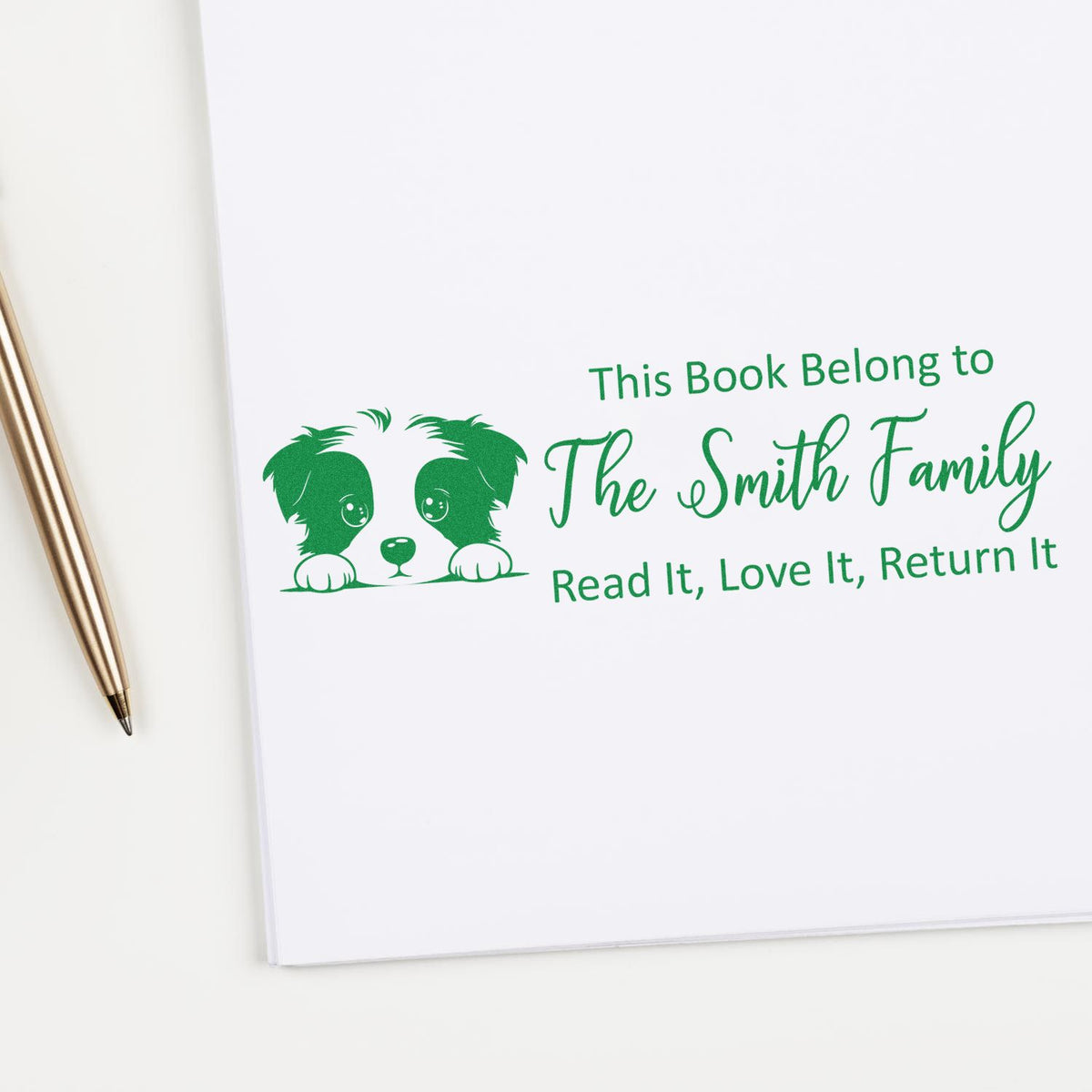 Personalized rubber book stamp with dog graphic and This Book Belong to The Smith Family return message.
