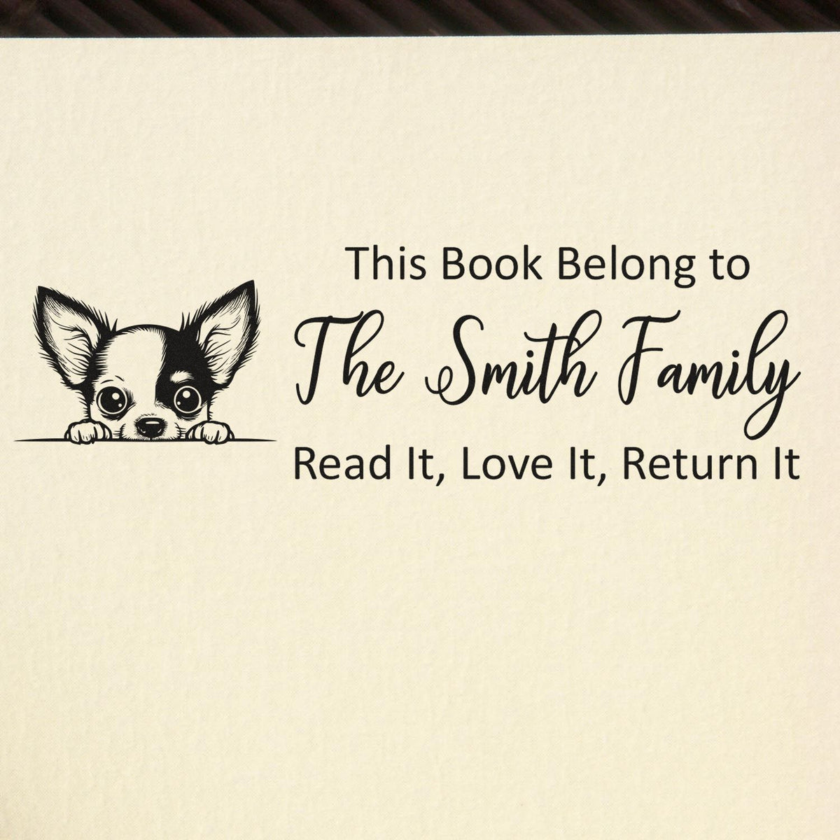 Personalized rubber stamp for books with dog illustration and This Book Belongs to The Smith Family return message.