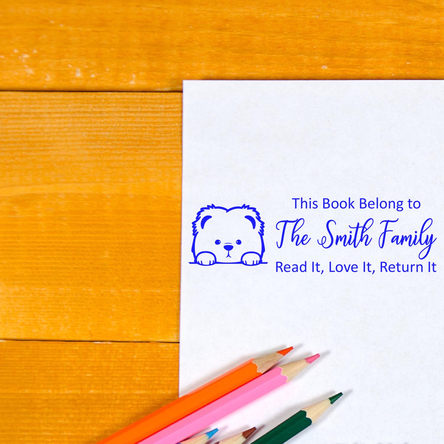 Custom rubber stamp book ownership stamp with bear design and return message for The Smith Family library books.