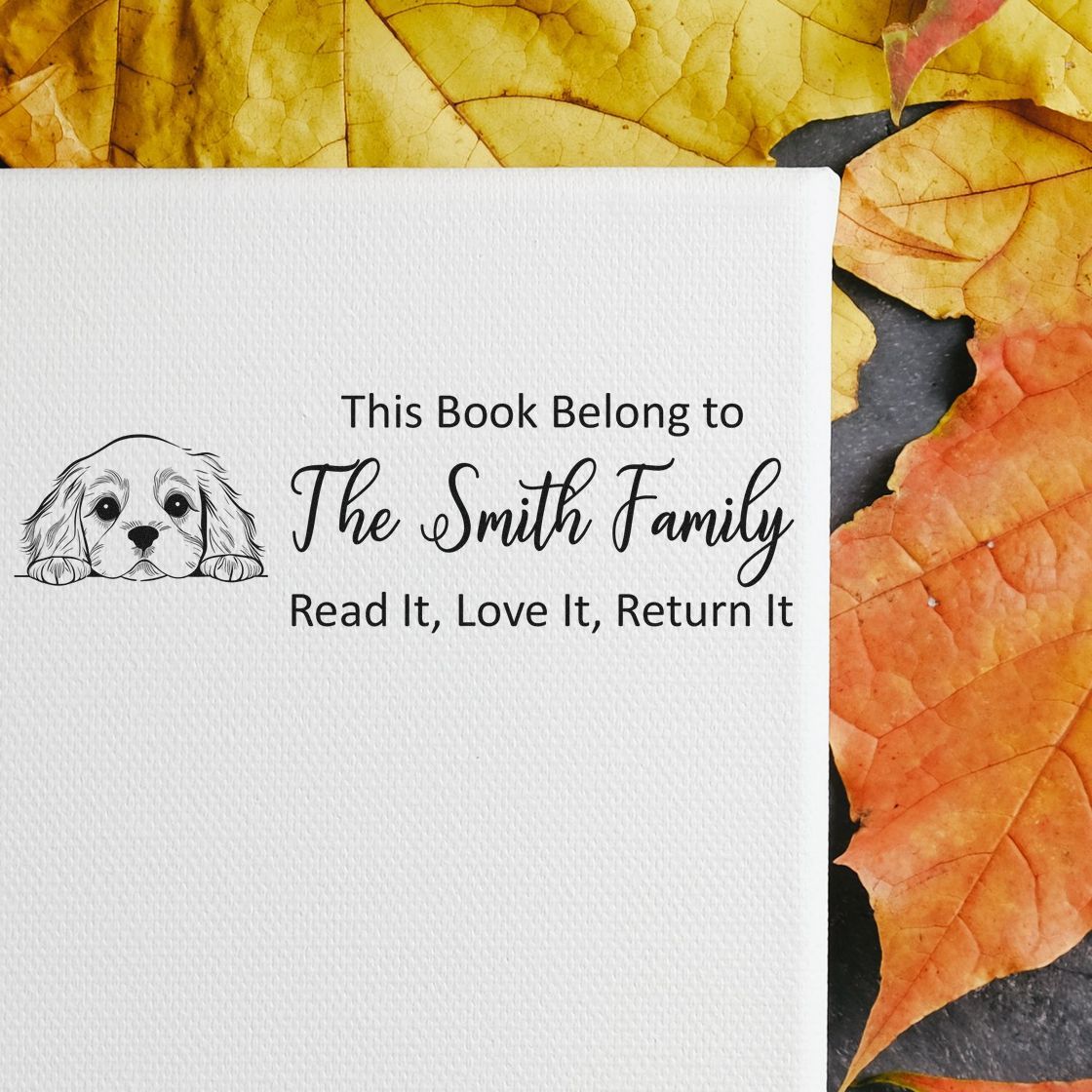 Personalized book rubber stamp for family library books with dog illustration and Read It, Love It, Return It message.