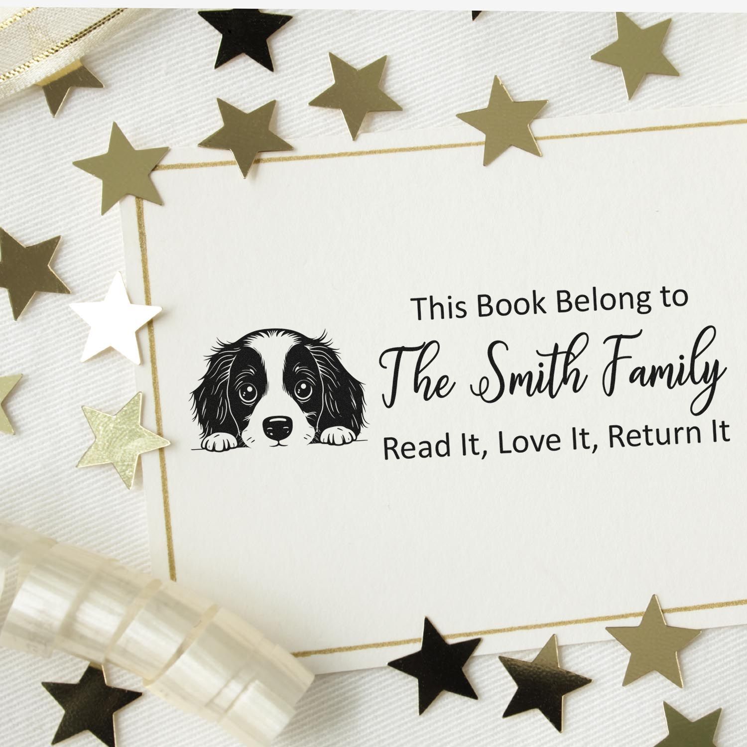 Personalized rubber book stamp with dog illustration and This Book Belongs to The Smith Family, Read It, Love It, Return It text