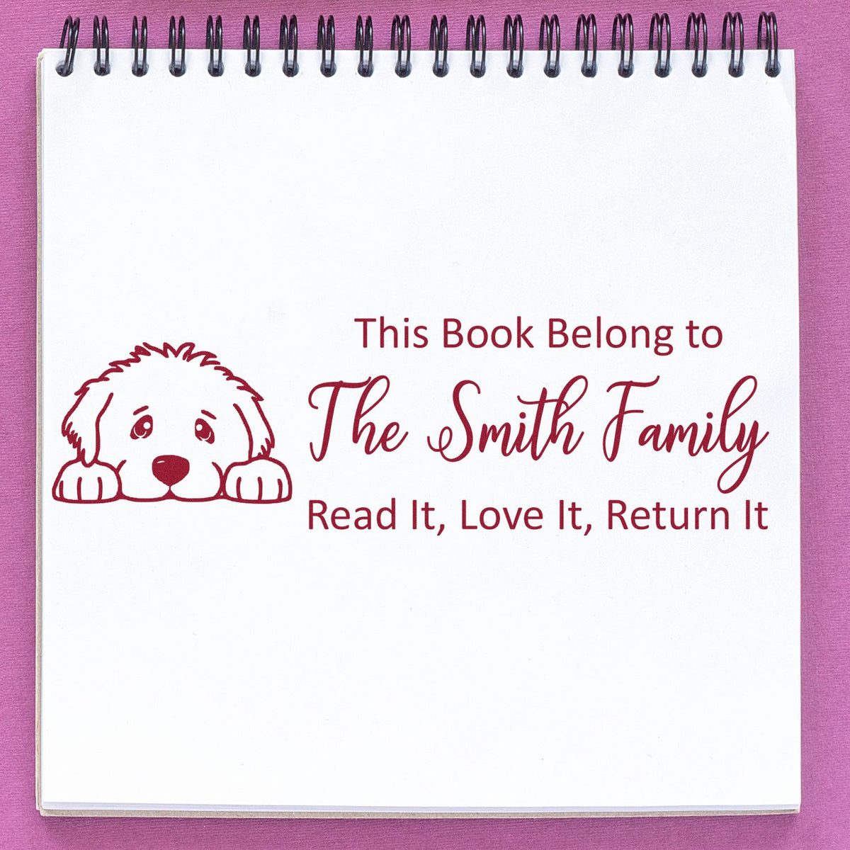 Personalized rubber book stamp with dog icon and return message for family books: This Book Belong to The Smith Family.