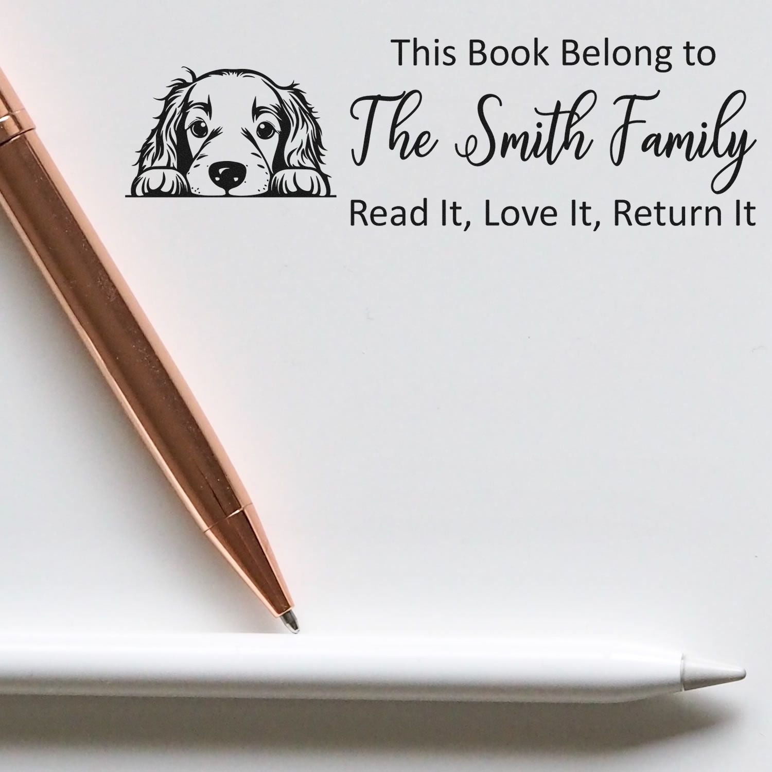 Personalized rubber book stamp with dog illustration, family name, and Read It, Love It, Return It message.