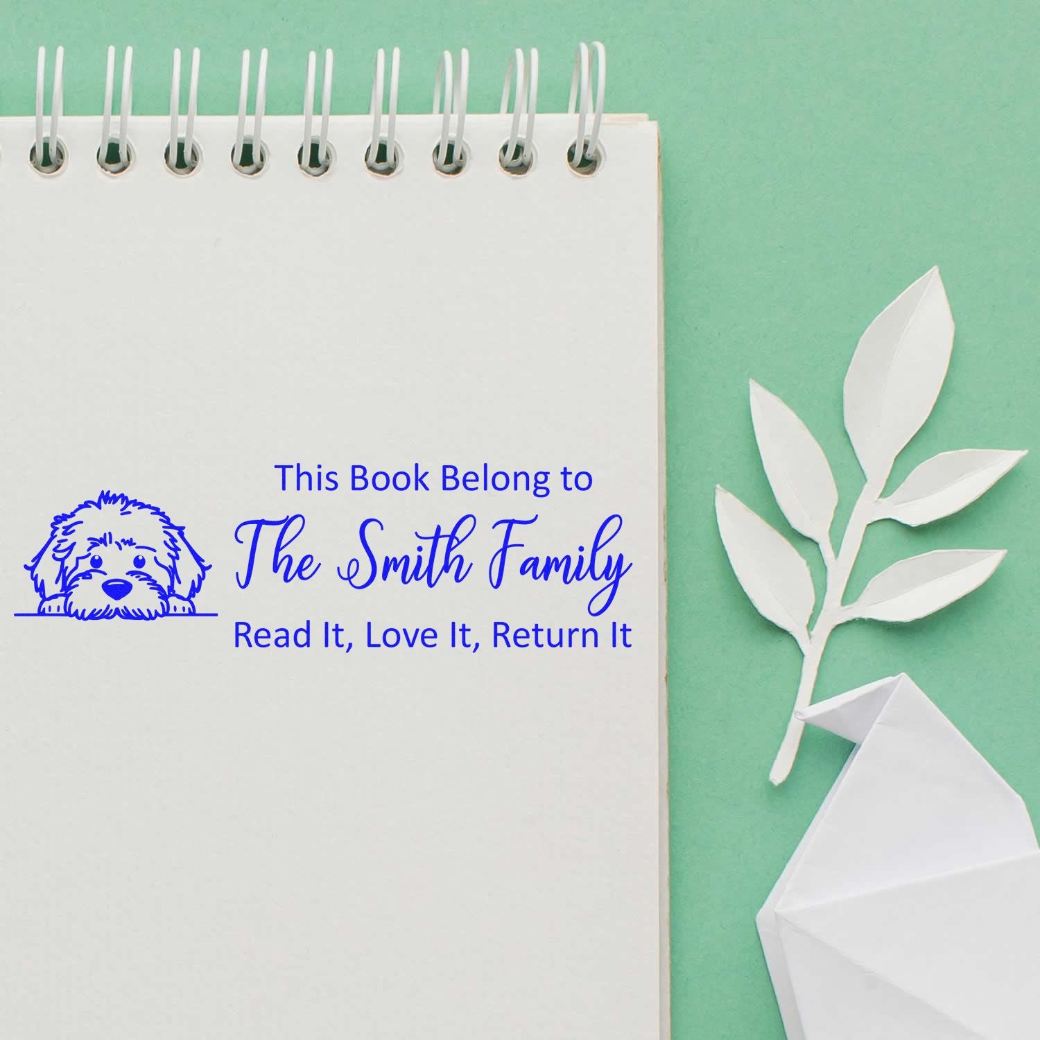 Personalized custom book stamp with dog icon and This Book Belongs to The Smith Family, Read It, Love It, Return It text.