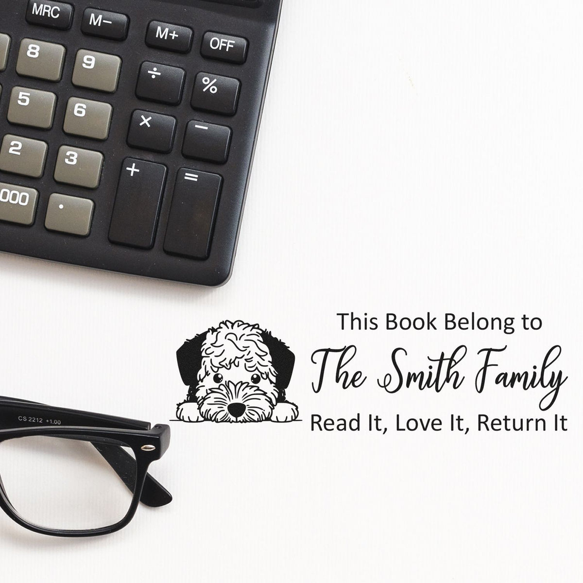 Custom rubber stamp for books with dog design and This Book Belongs to The Smith Family for personal library marking.