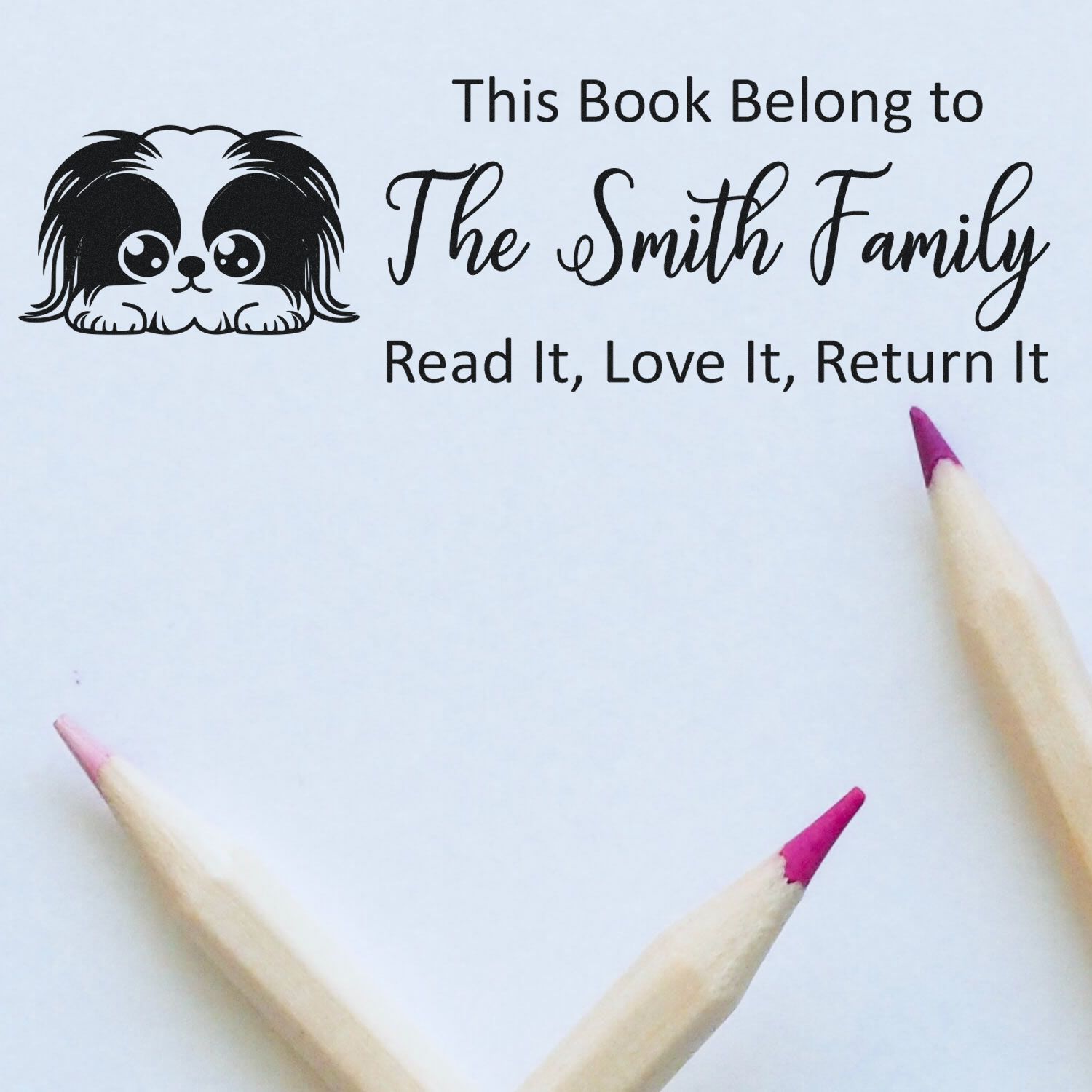 Custom rubber stamp for books: This Book Belongs to The Smith Family, Read It, Love It, Return It with dog icon.