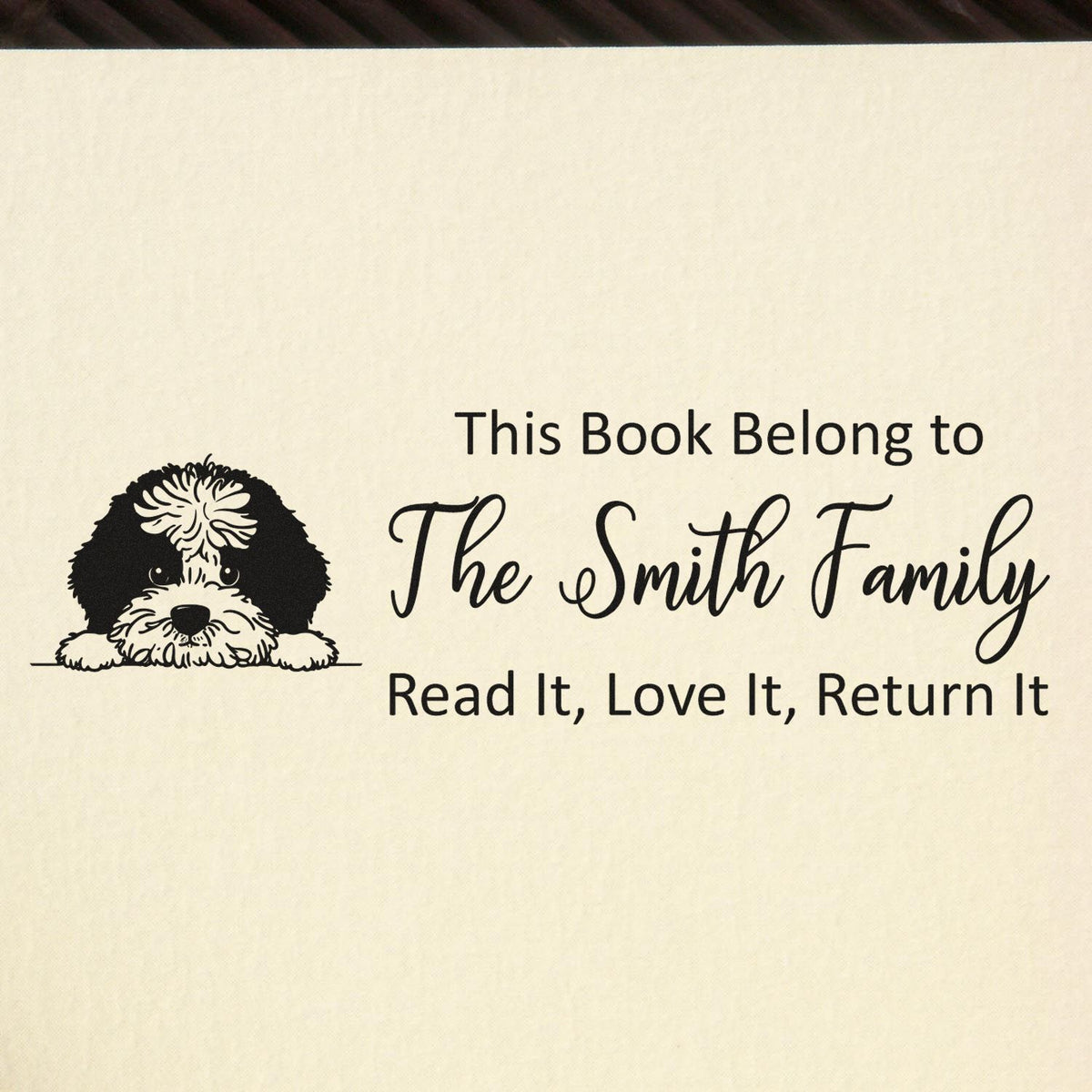 Personalized rubber book stamp with dog illustration: This Book Belongs to The Smith Family and Read It, Love It, Return It message.