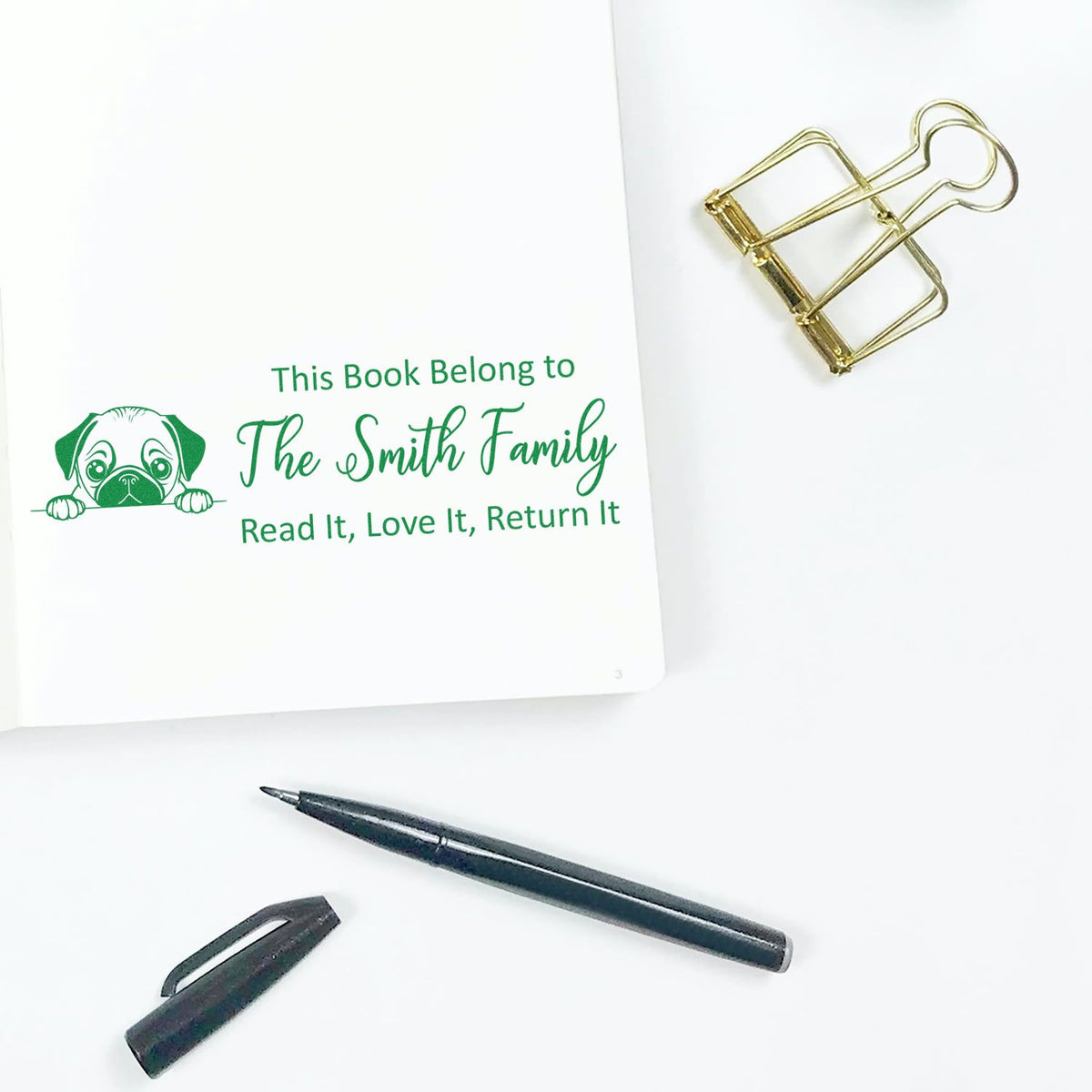 Personalized family book stamp with dog icon and return message, ideal for custom library stamps and home book collections.