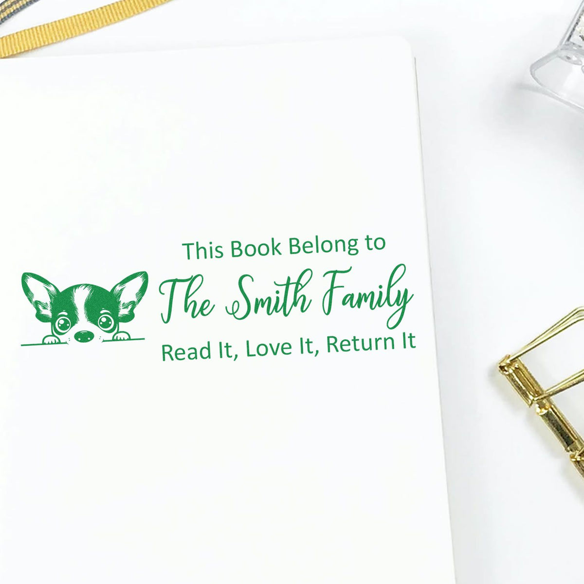 Personalized rubber book stamp with dog design for The Smith Family, reading Read It, Love It, Return It.