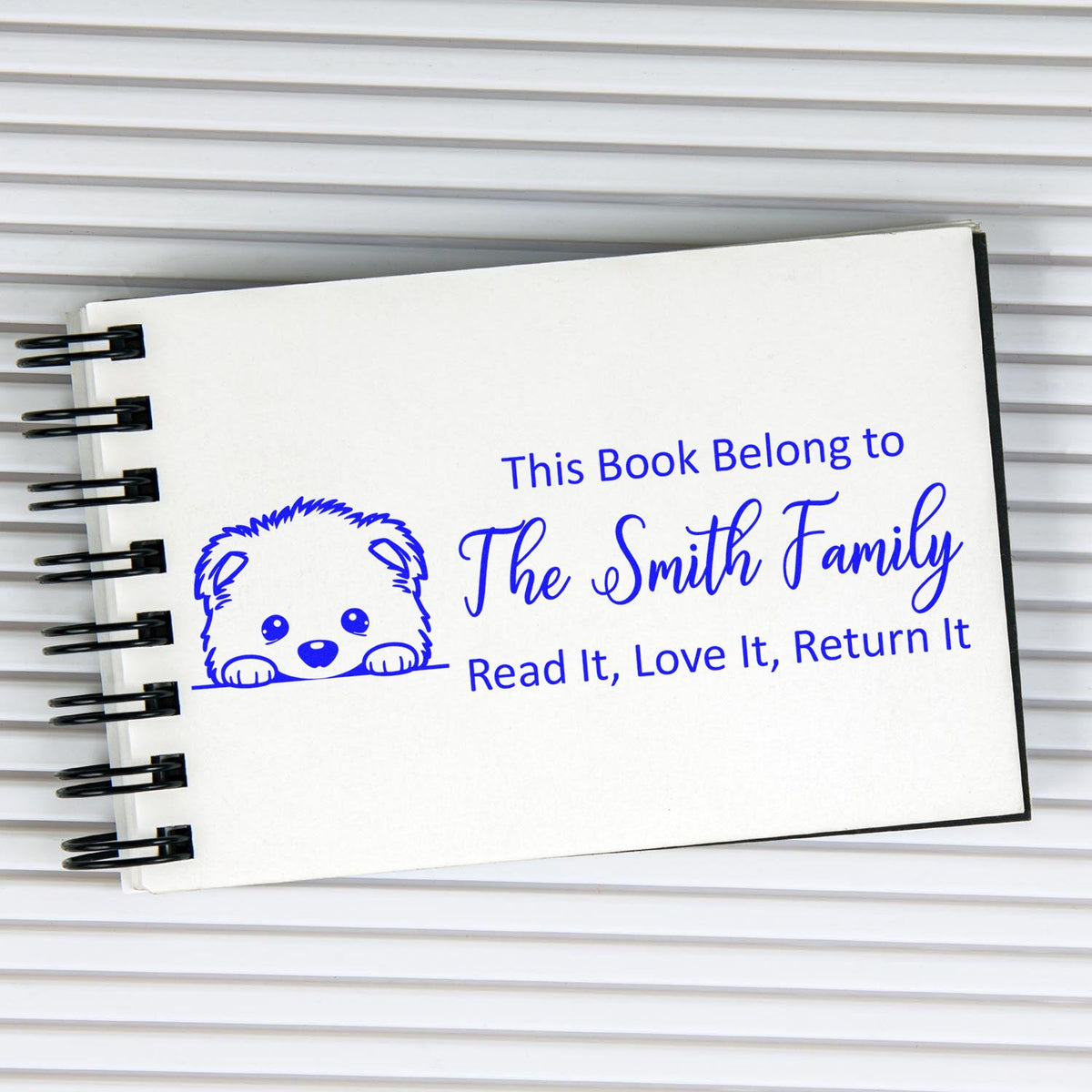 Custom rubber book stamp for The Smith Family with bear design and Read It, Love It, Return It message.