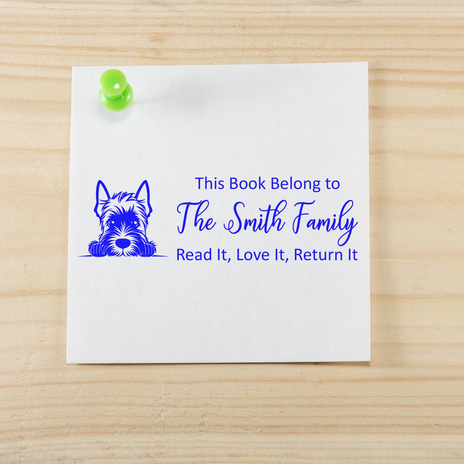 Personalized rubber stamp for books with dog design and This Book Belong to The Smith Family return message.