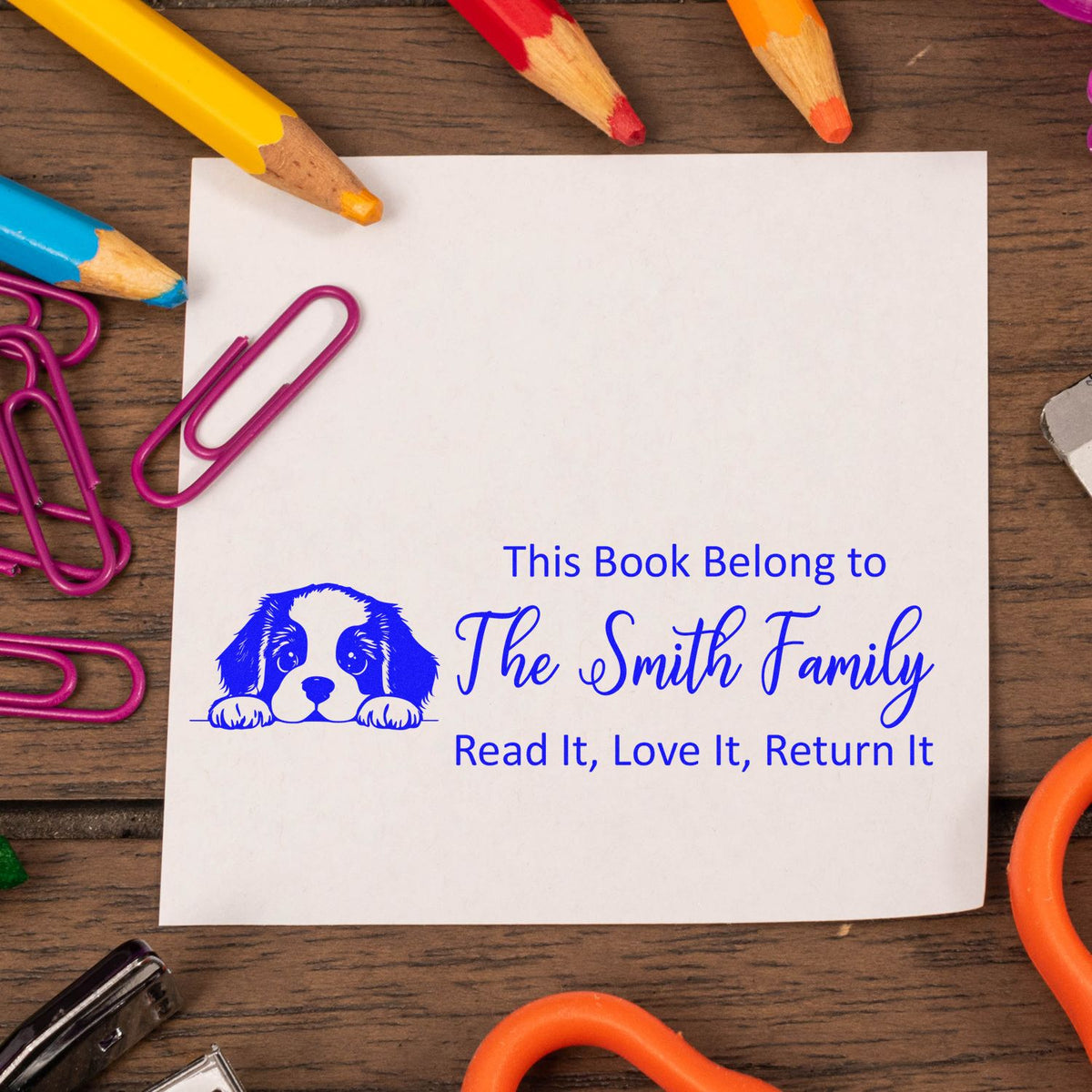 Personalized rubber book stamp for The Smith Family, featuring a dog icon and Read It, Love It, Return It ownership label.