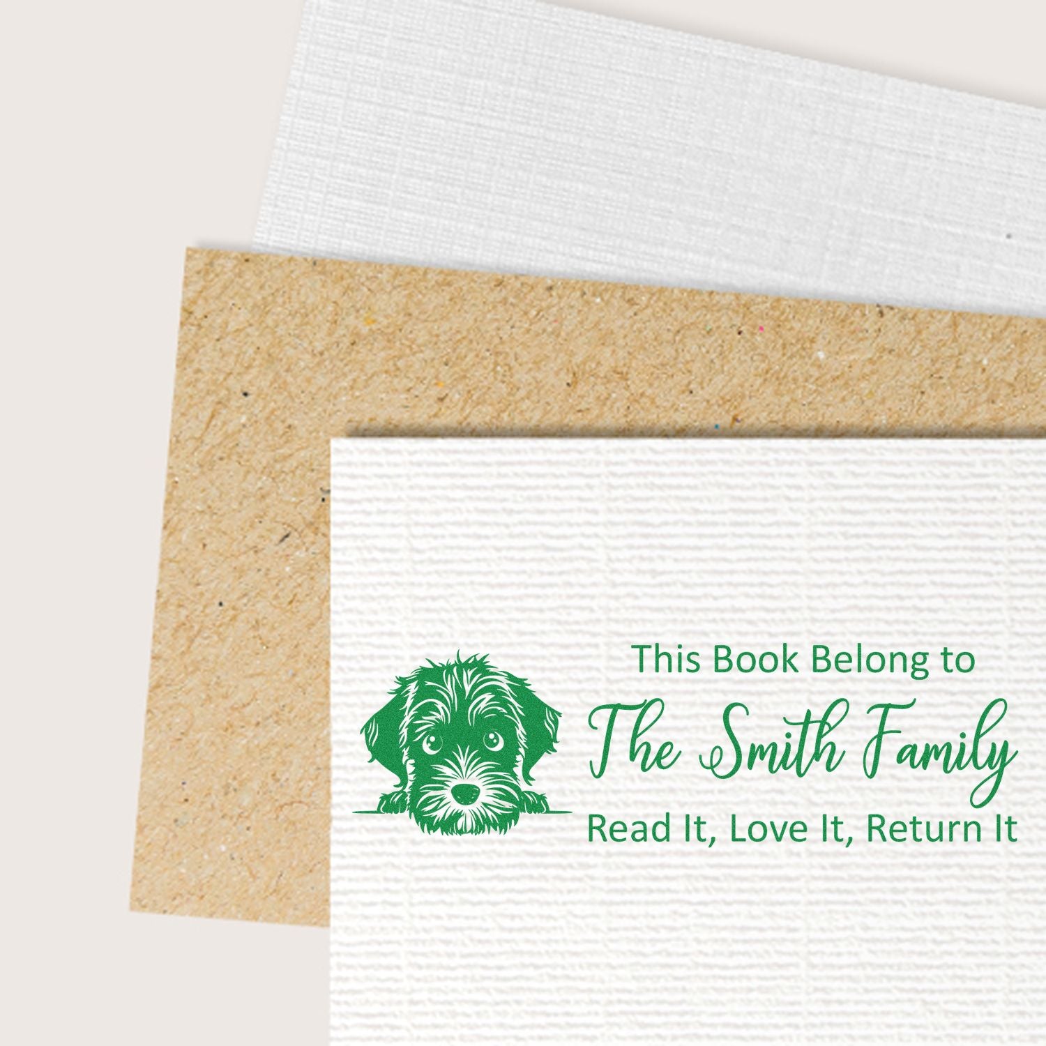 Personalized rubber book stamp with dog design for The Smith Family, marking books Read It, Love It, Return It.