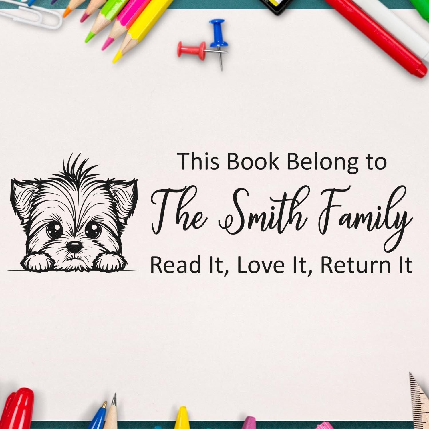 Personalized book rubber stamp with dog graphic and This Book Belongs to The Smith Family return message for library books.