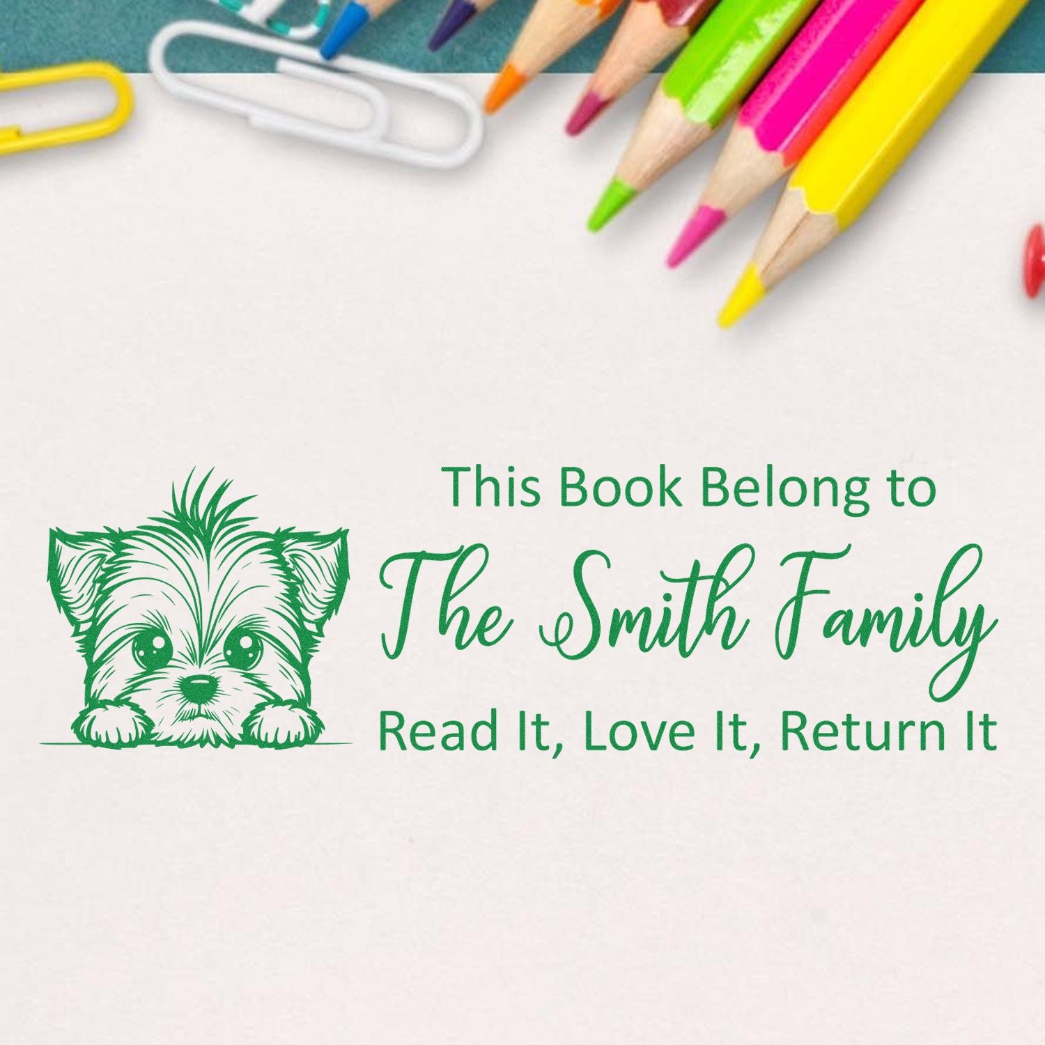 Personalized rubber book stamp with puppy design and This Book Belongs to The Smith Family return-it message.