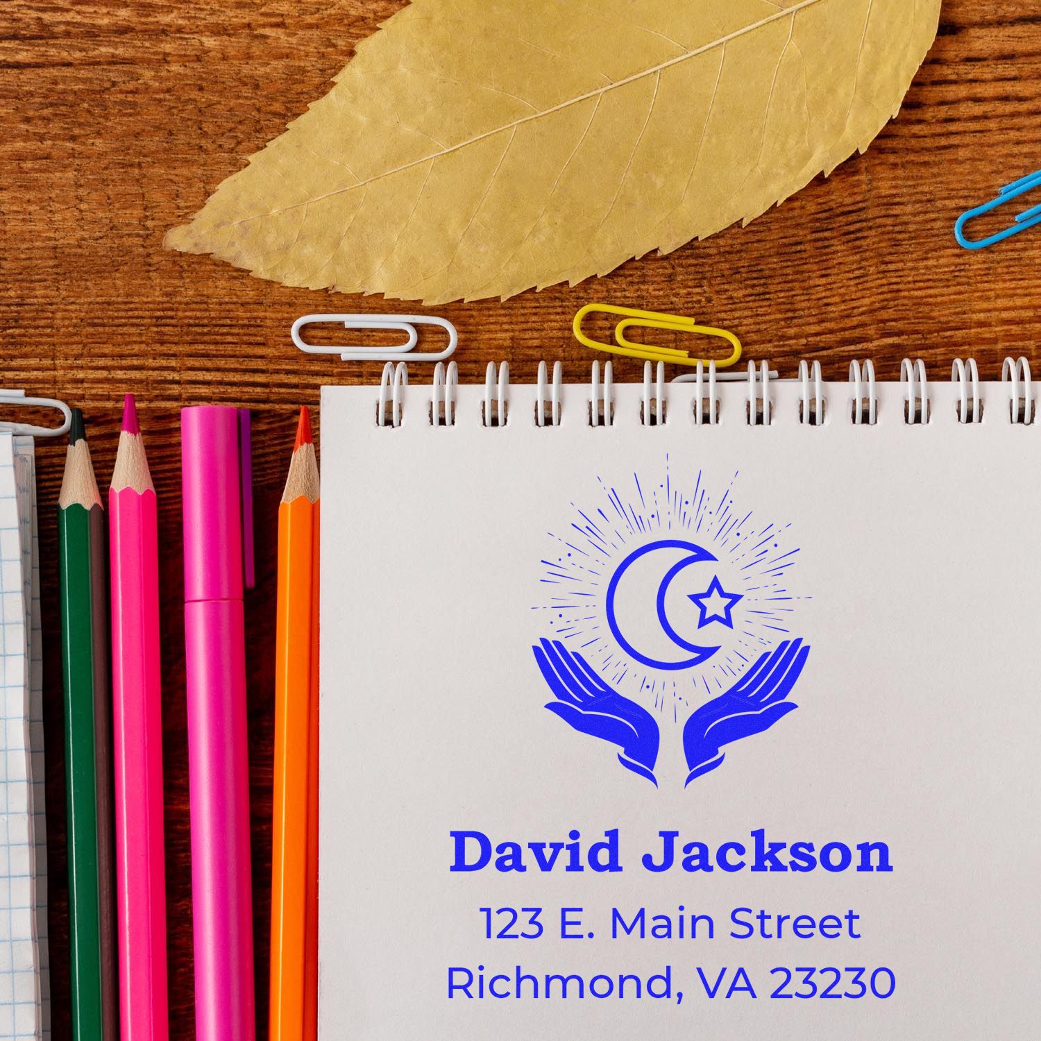 Custom address rubber stamp mockup on notebook with name, logo, and address for personalized business branding.