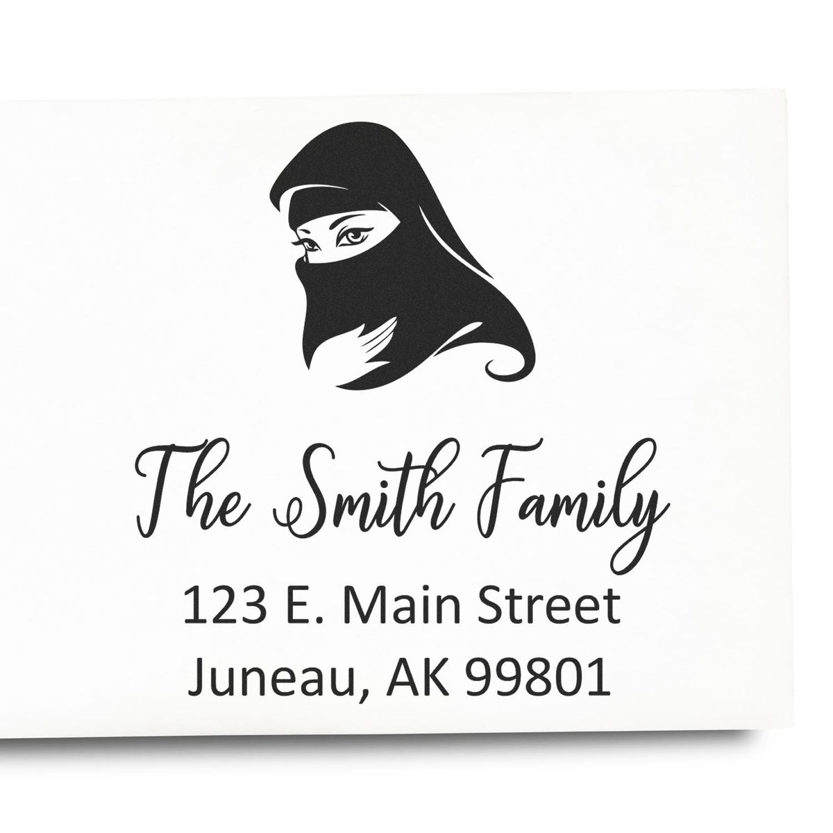Custom return address rubber stamp with veiled woman design, The Smith Family, Juneau, AK 99801.