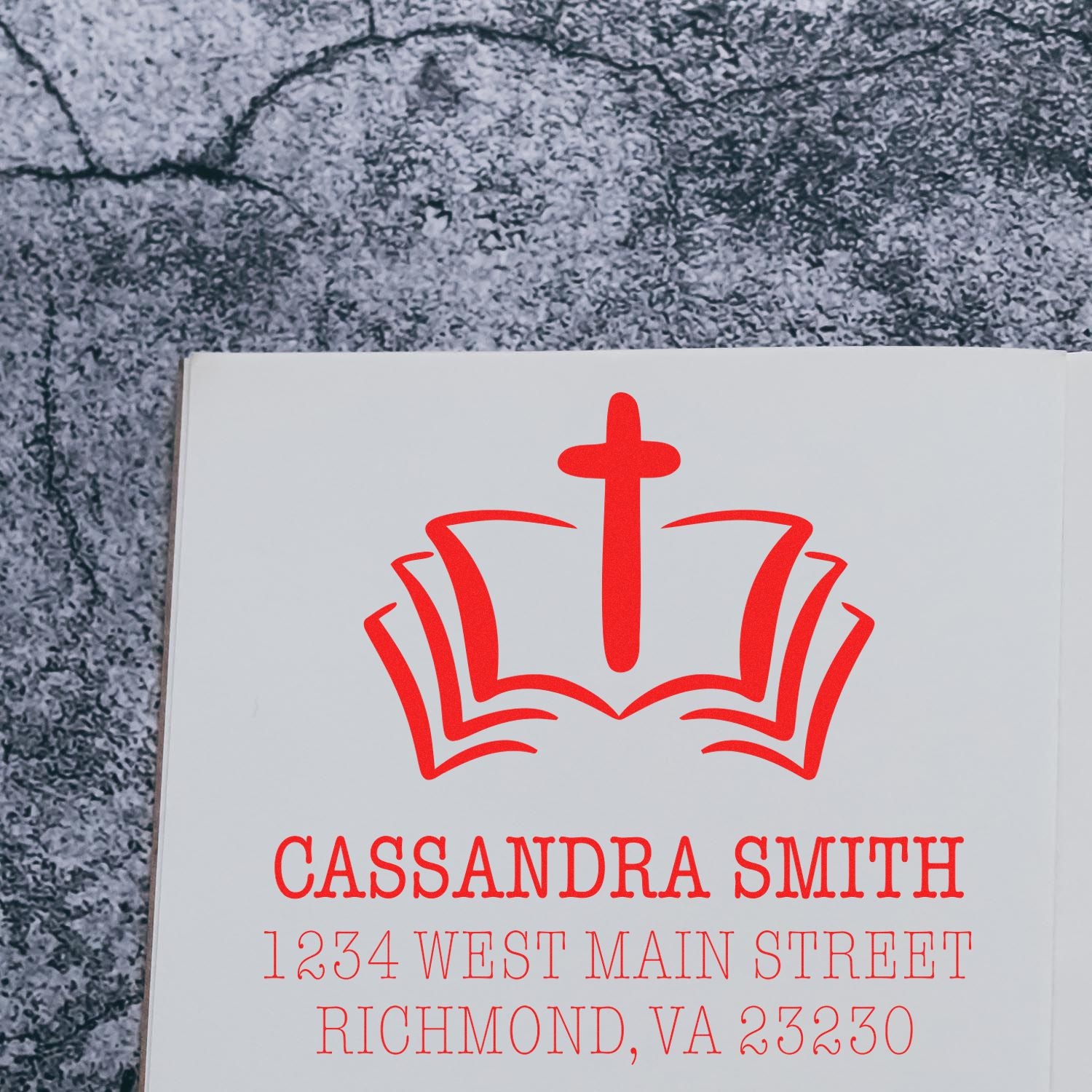 Custom rubber stamp proof with church cross and book logo, personalized return address stamp for Cassandra Smith, Richmond VA.