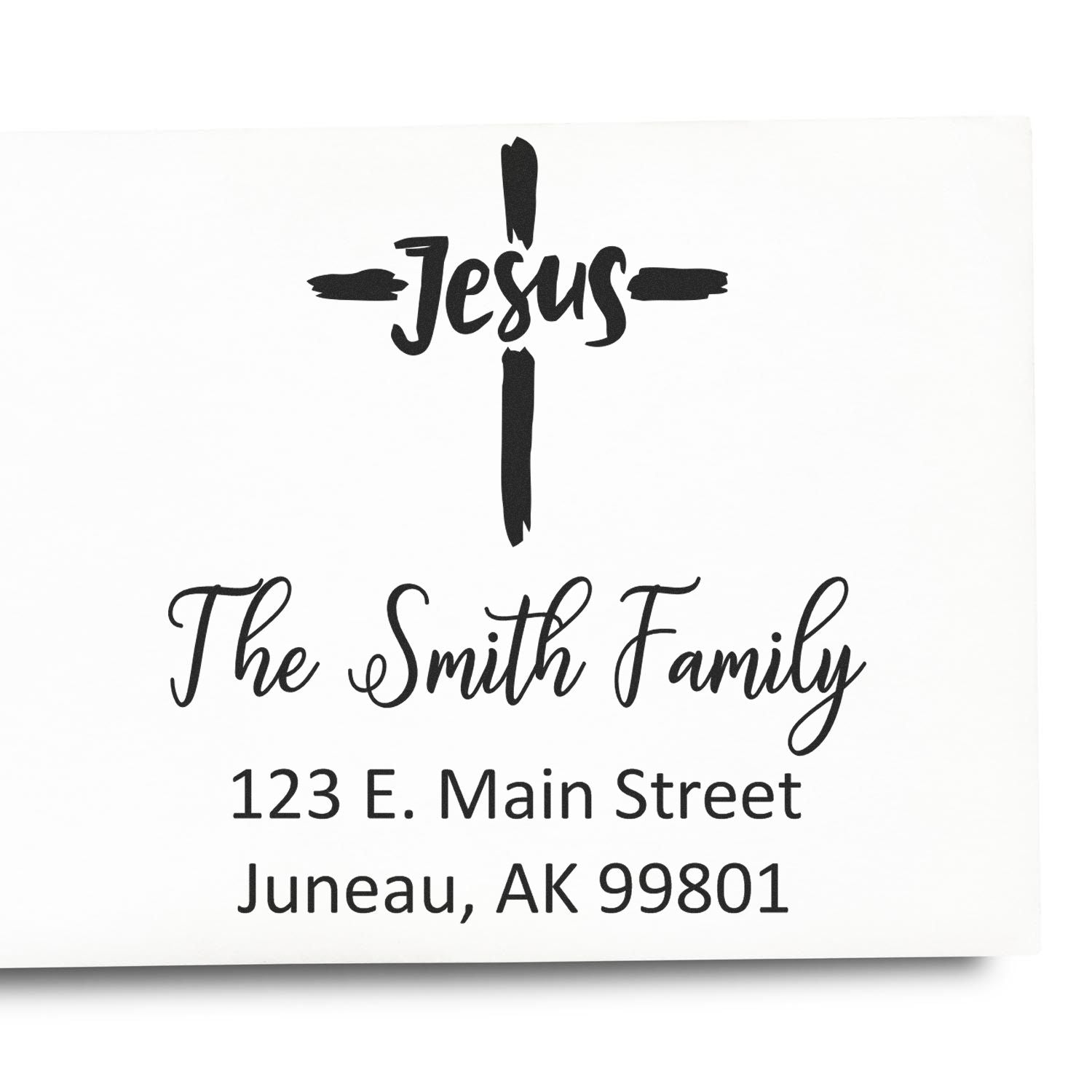 Custom Christian family address stamp with cross and Jesus design for The Smith Family, 123 E. Main Street, Juneau, AK 99801.