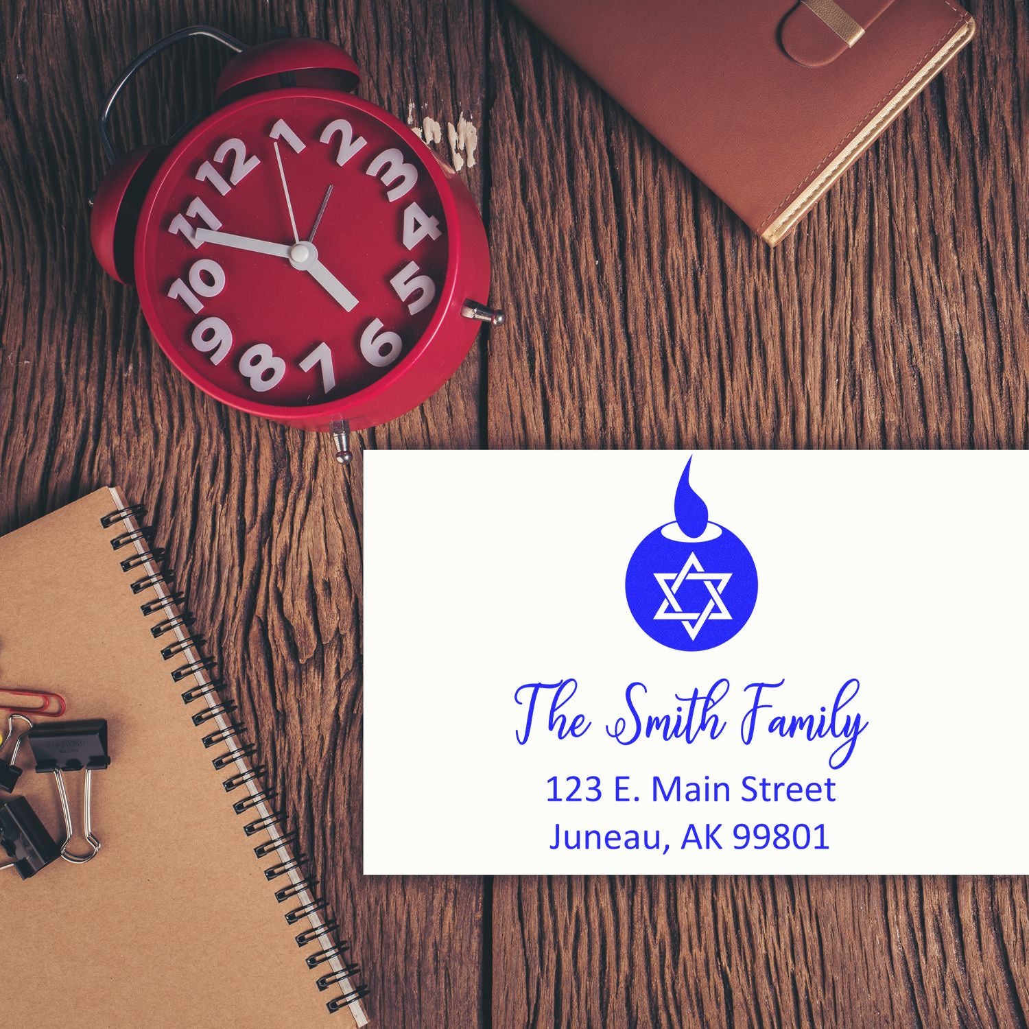 Custom return address rubber stamp with family name, address, and blue Star of David design for personalized stationery.