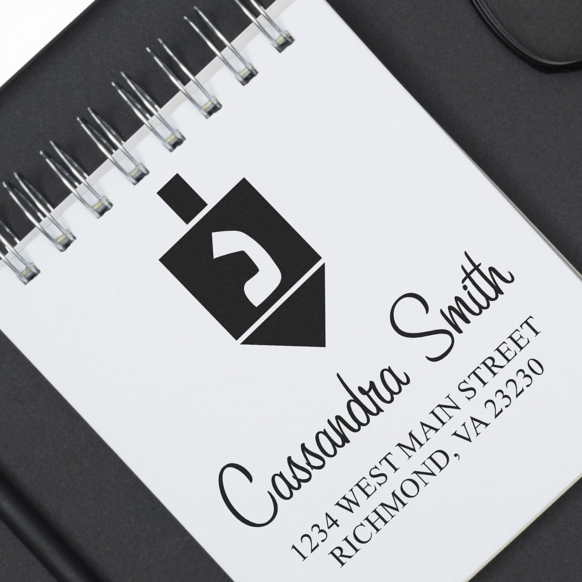 Custom rubber address stamp design with name, logo, and return address for personalized business mailing and branding.
