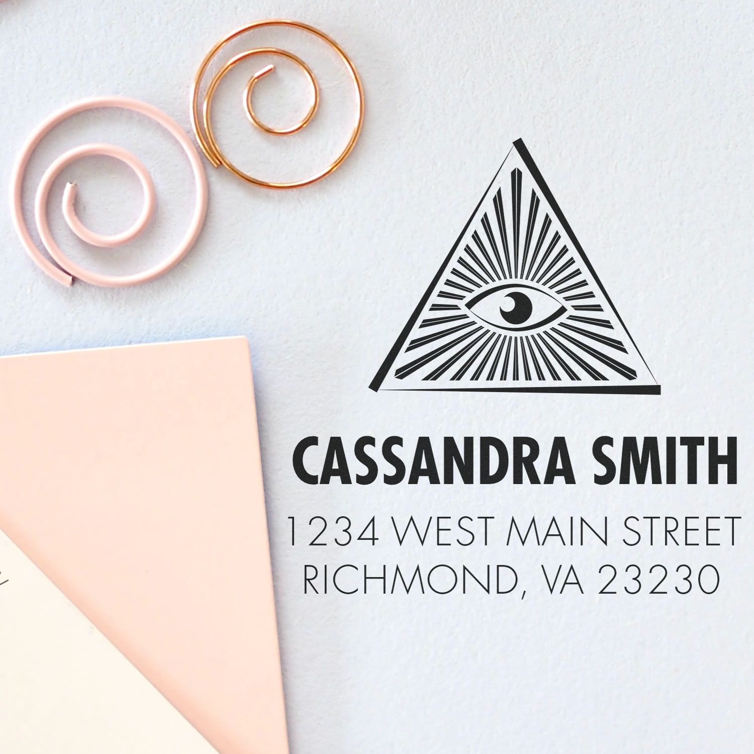 Custom return address rubber stamp with eye pyramid logo for Cassandra Smith, Richmond, VA