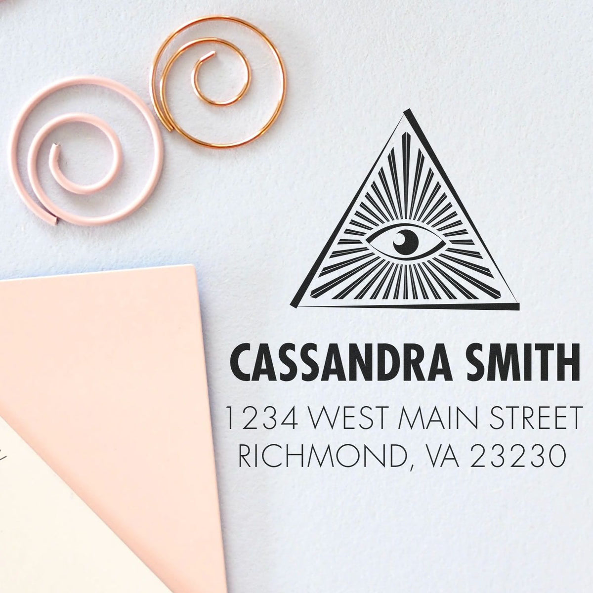 Custom rubber address stamp with eye-in-pyramid logo for Cassandra Smith, Richmond VA return address.
